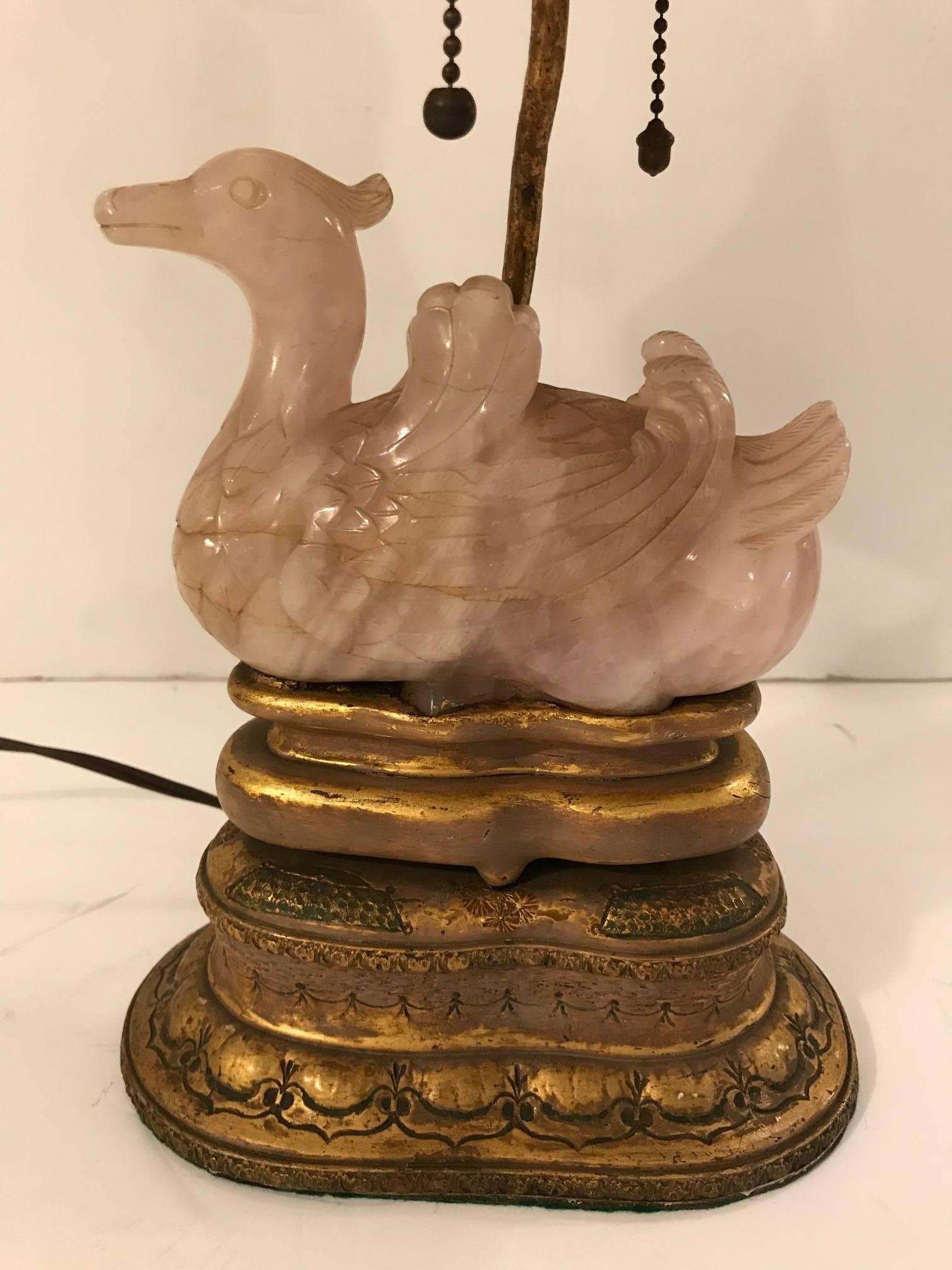A gorgeous sculptural Chinese rose quartz swan lamp with giltwood and bronze and 
Carved bone finial with custom shade. 

