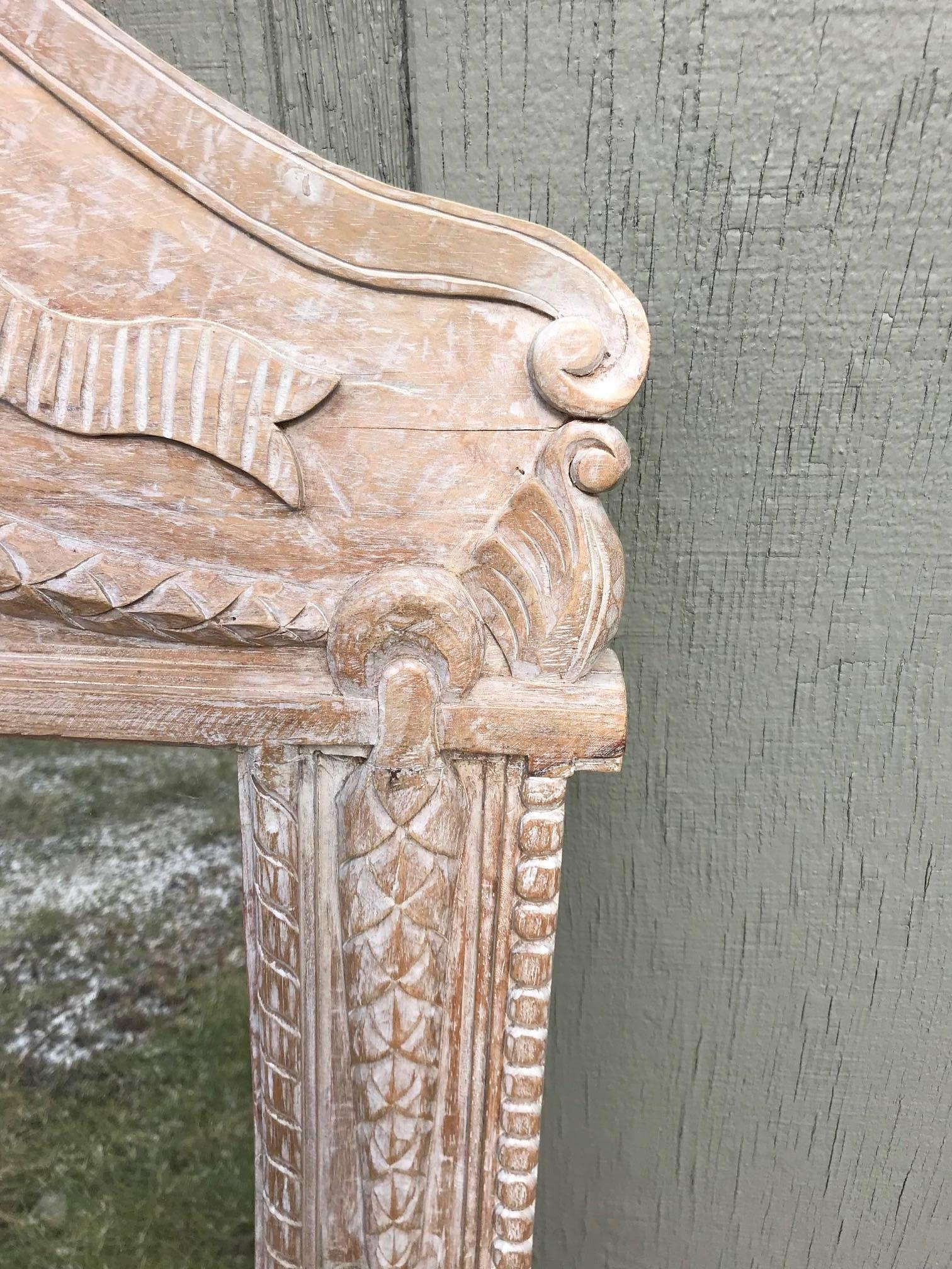 Two lovely natural pine carved wood mirrors in the French style having pretty ribbons and bows at curvy tops.