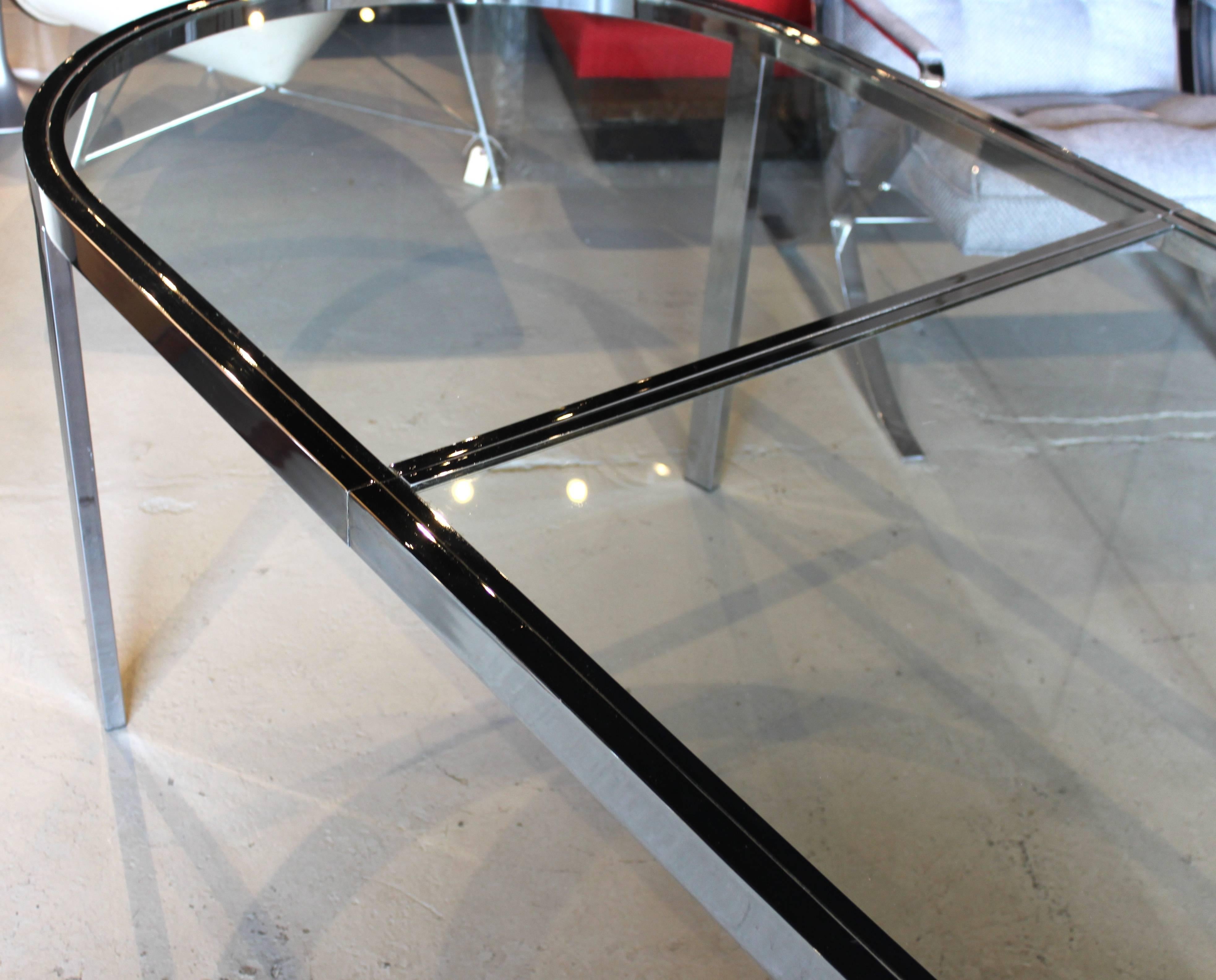 Design Institute of America. Glass and chrome racetrack dining table.

Without leaves: 80.5" long.
With one leaf: 95.5" long.
With two leaves: 110.5" long.

(Each leaf = 15").