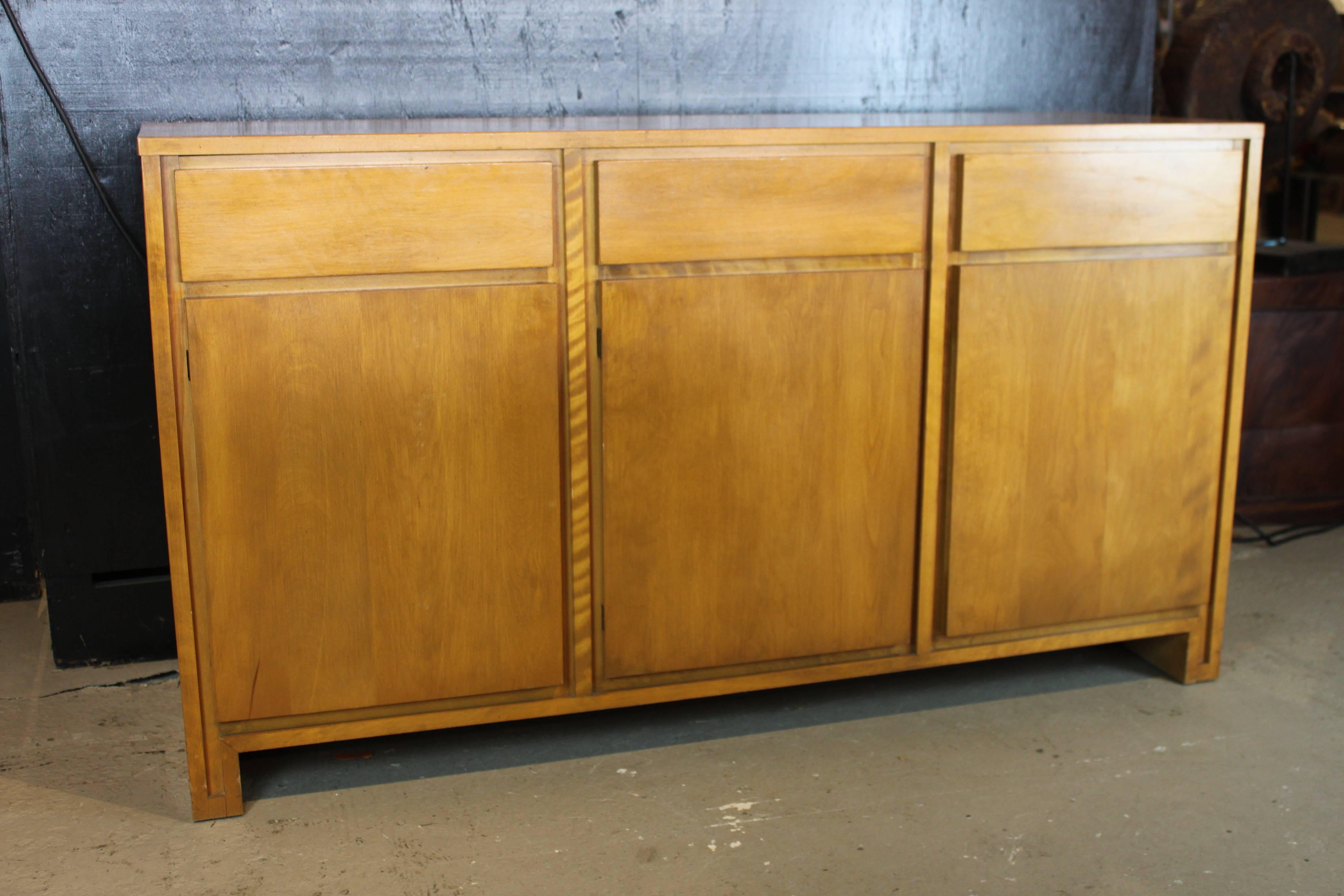 Solid maple wood sideboard designed by Russell Wright for Conant Ball in original finish. Overall in mint condition. Few minor nicks on the wood.