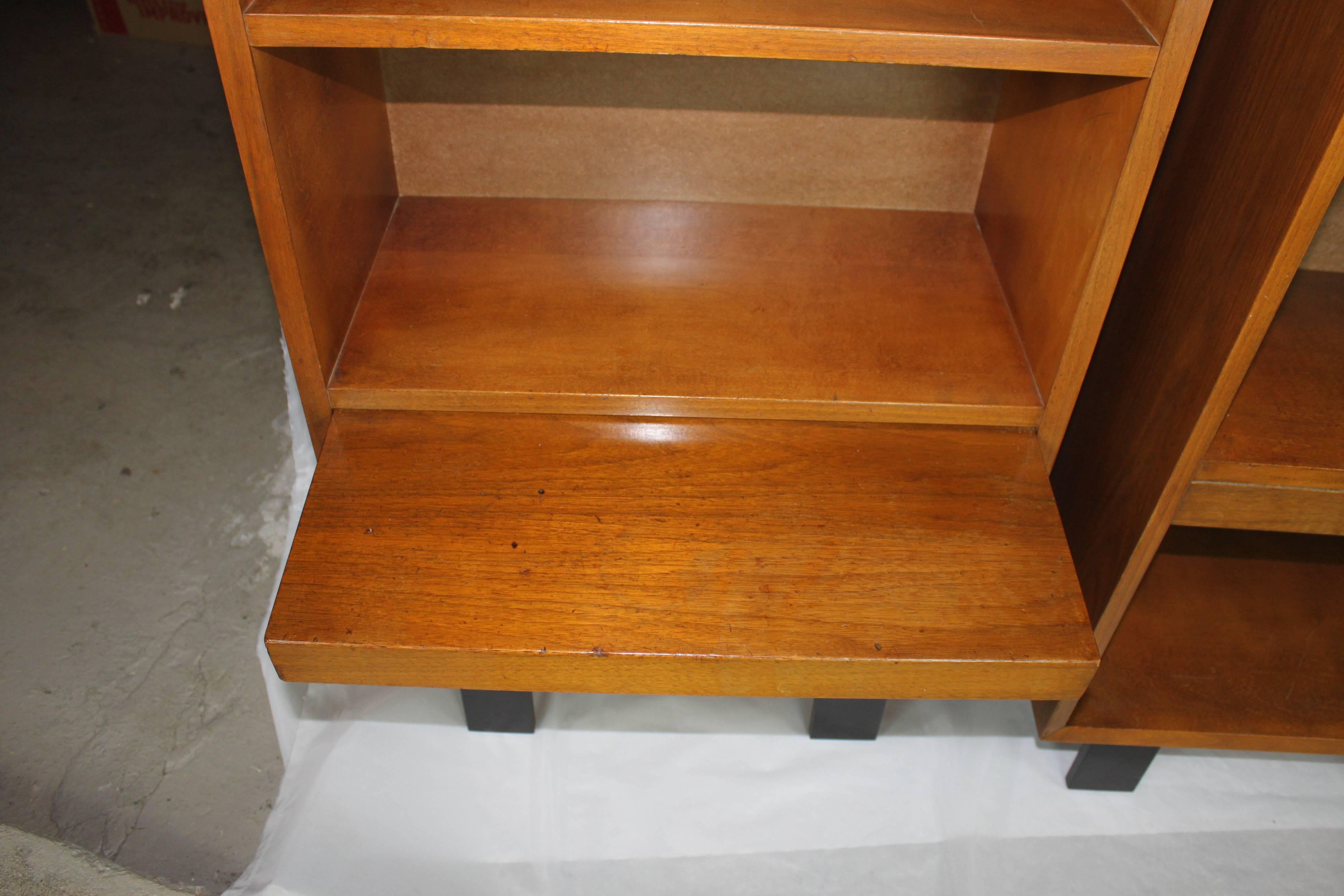 George Nelson walnut bookcase nightstands. Both pieces have pull-out shelf. Signature George Nelson ebonized legs.