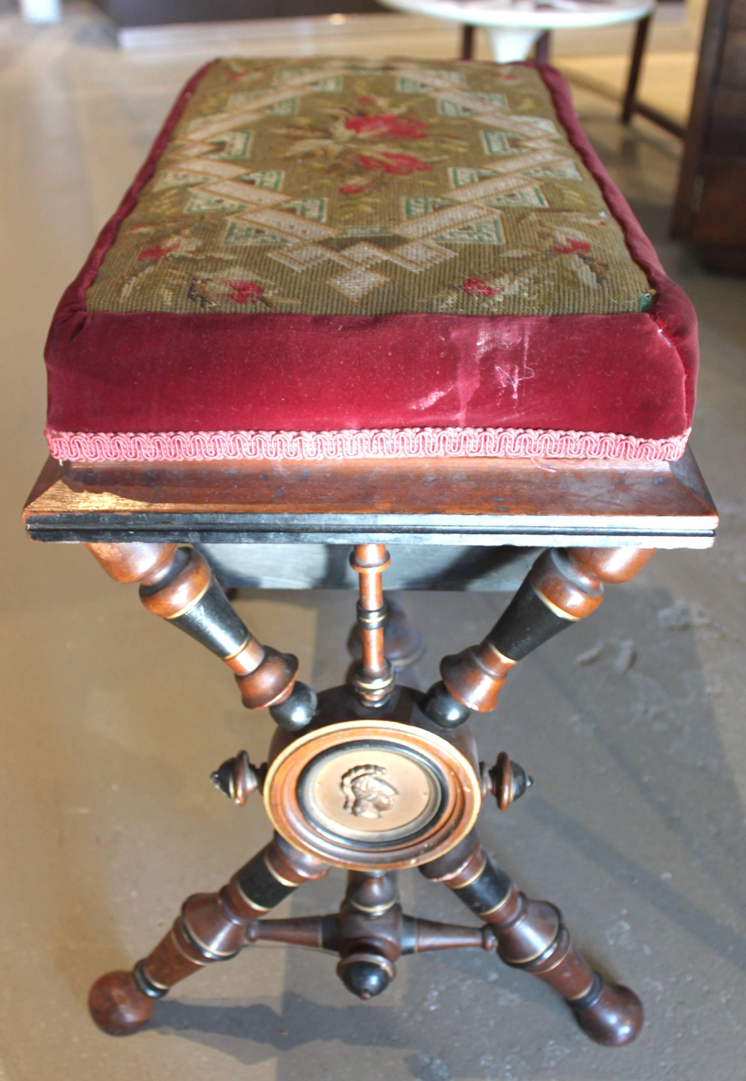 Antique Victorian needlepoint stool with classical motifs.