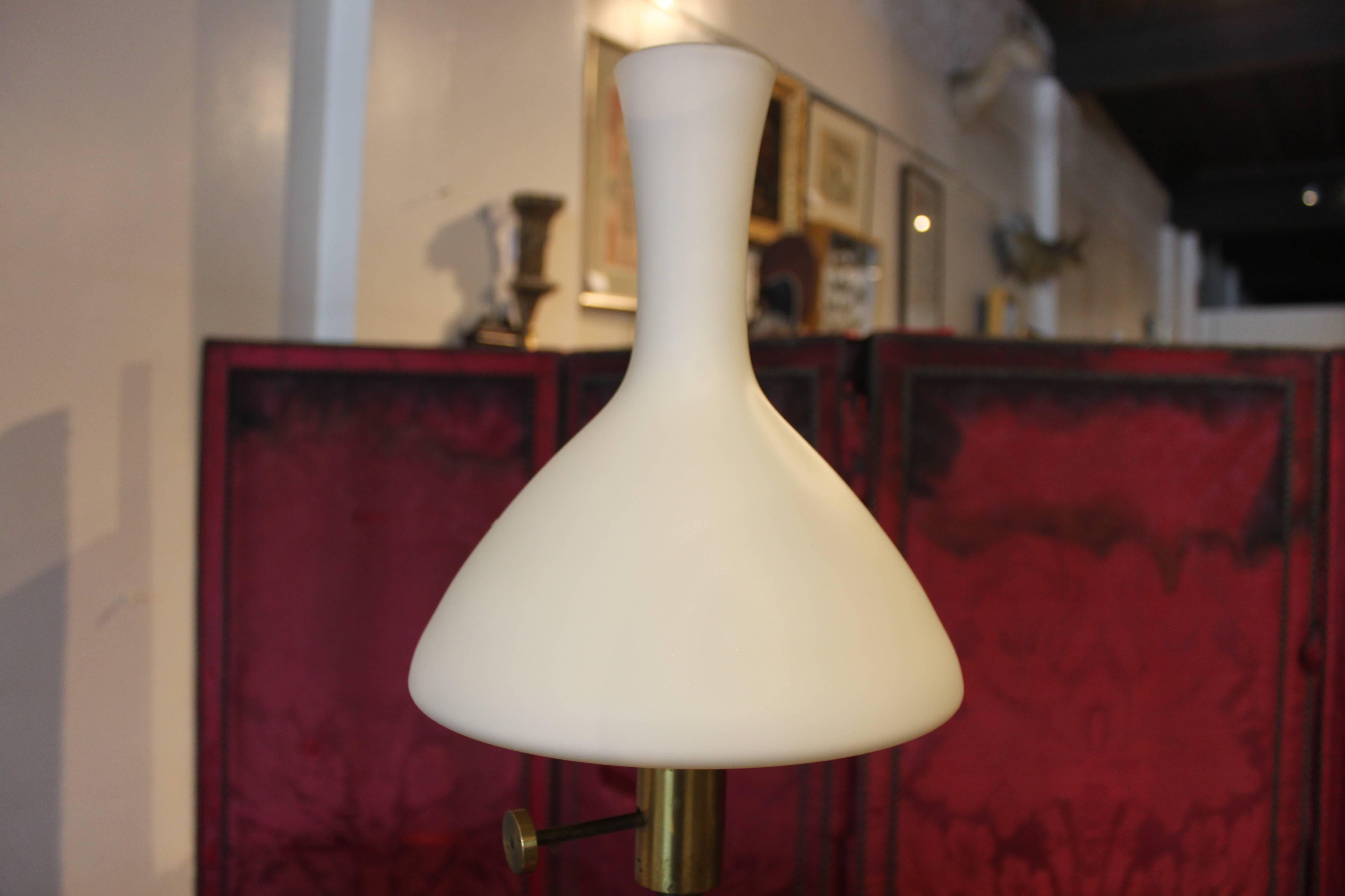 This table lamp is reminiscent of an antique oil lamp yet retains a strong mid-century design. Frosted milk glass shade makes this lamp special.