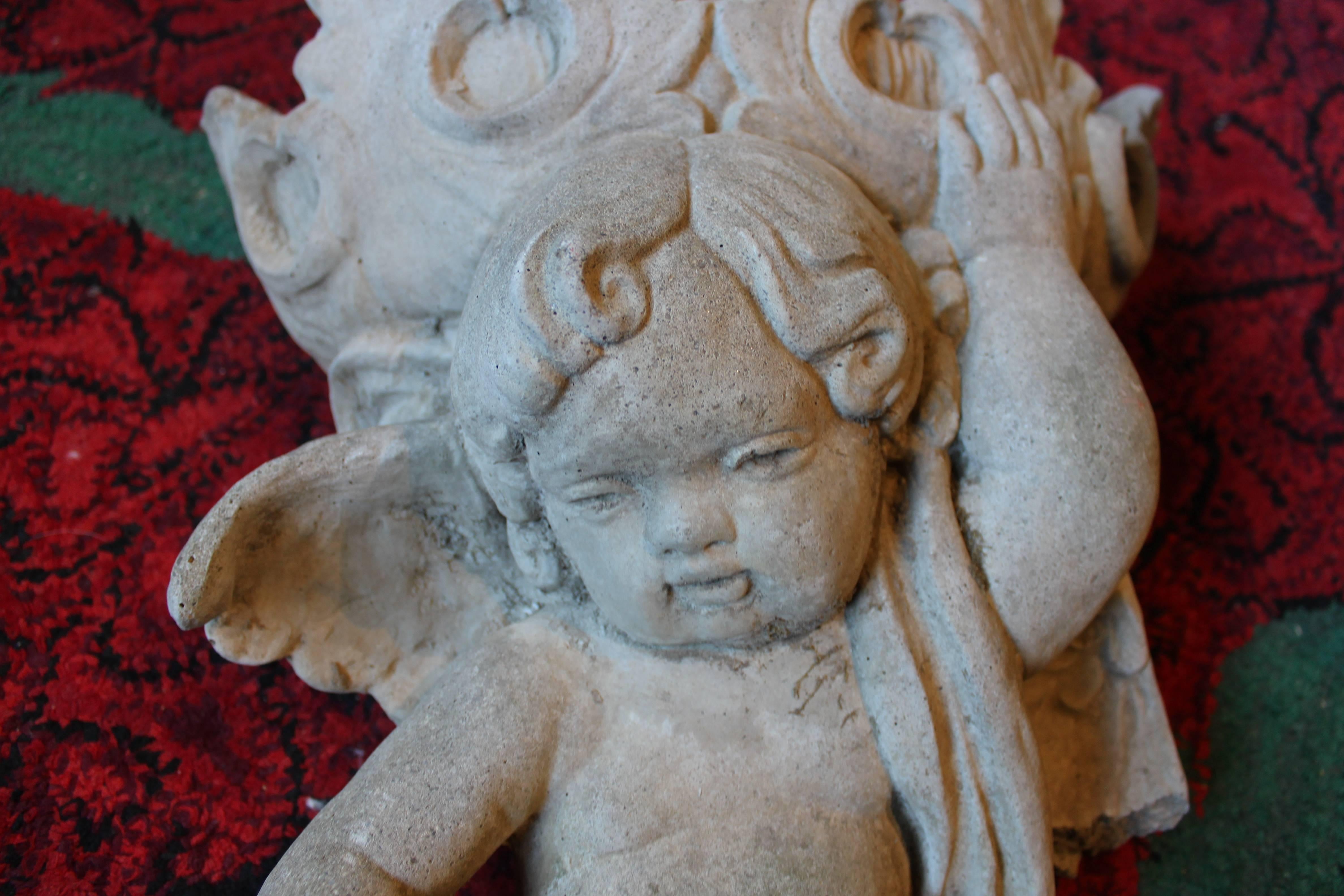 Vintage casted cement cherub. Beautiful patina. Minor loss on wing. Please see picture.