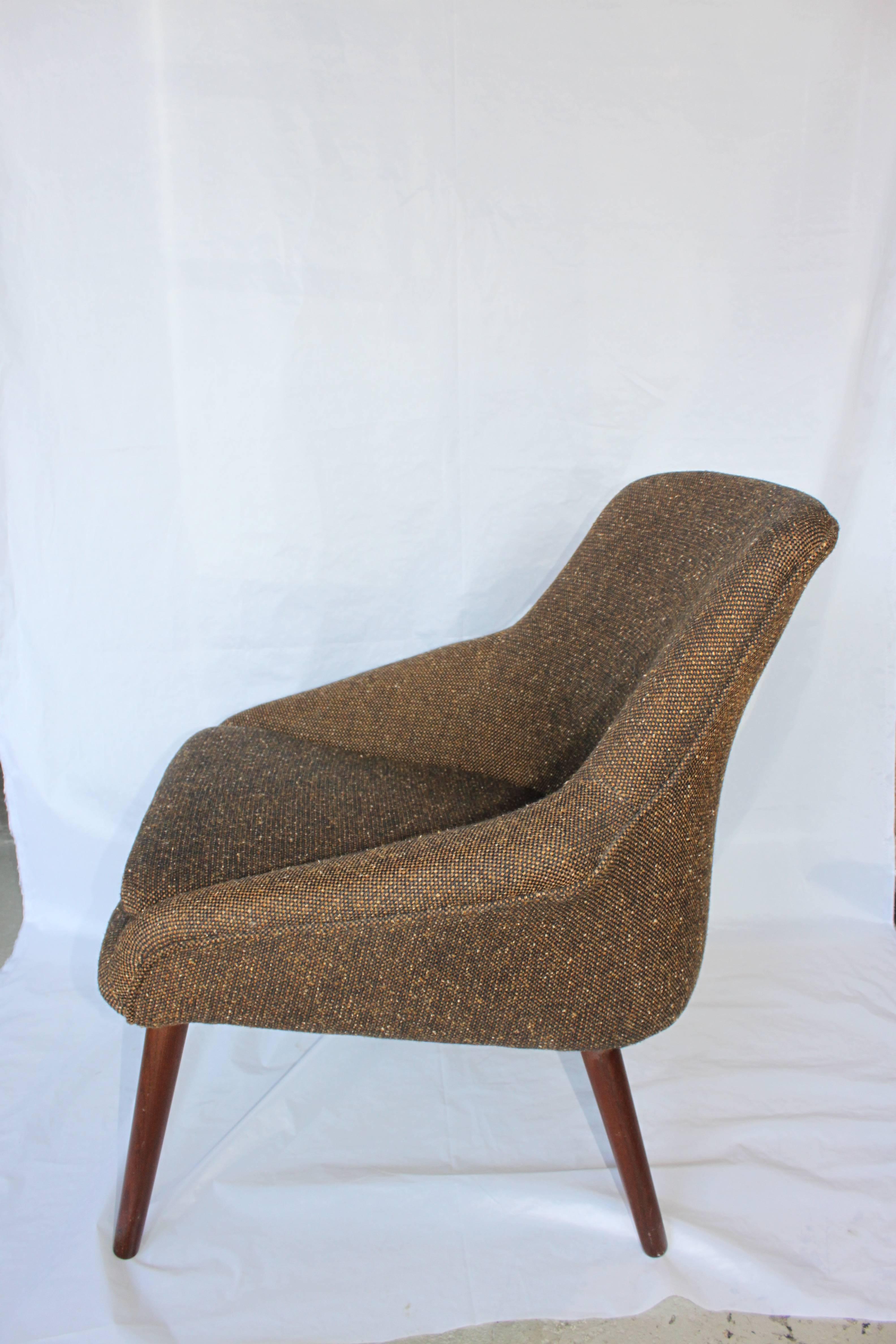 Beautiful lounge chair with walnut legs. No visible markings or labels. Awesome Mid-Century Modern design. Seat cushion and chair are still soft and supple. Fabric is in great shape and it could have been original to the chair but not sure.
