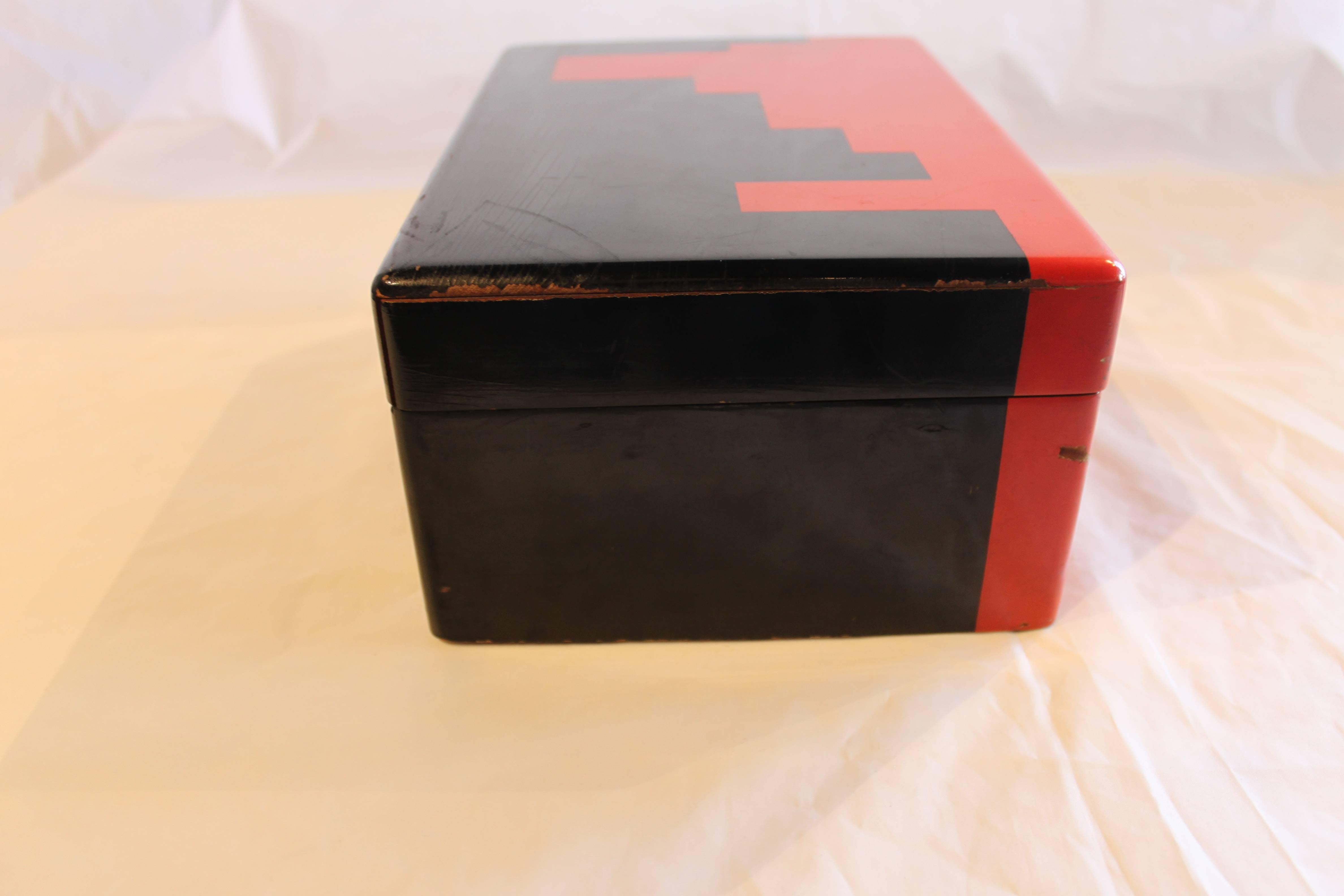 Red and black lacquer box with bakelite chips. Very good condition.