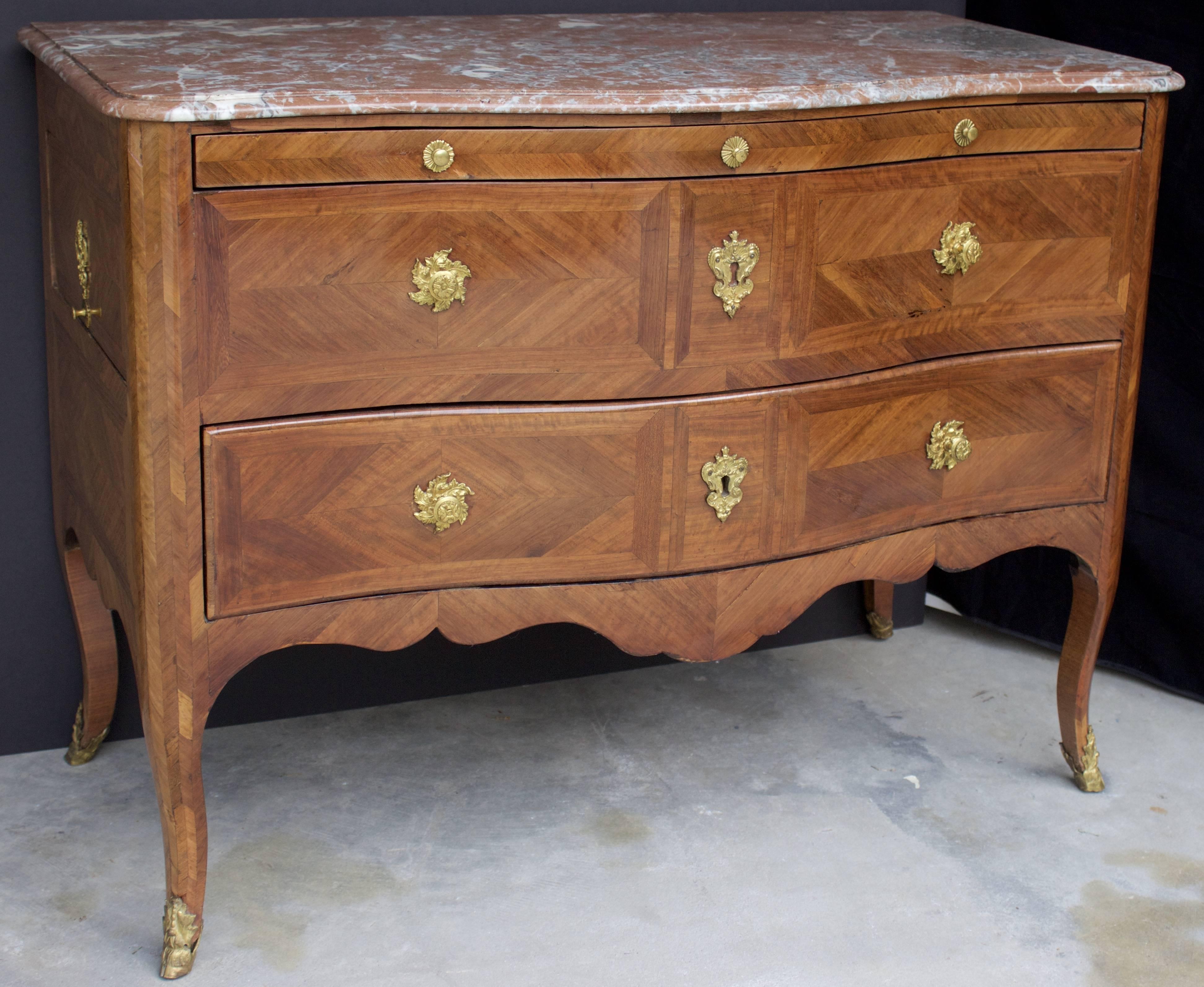 A truly unique French transition period commode with four drawers. From the front there is a thin top Drawer next a 