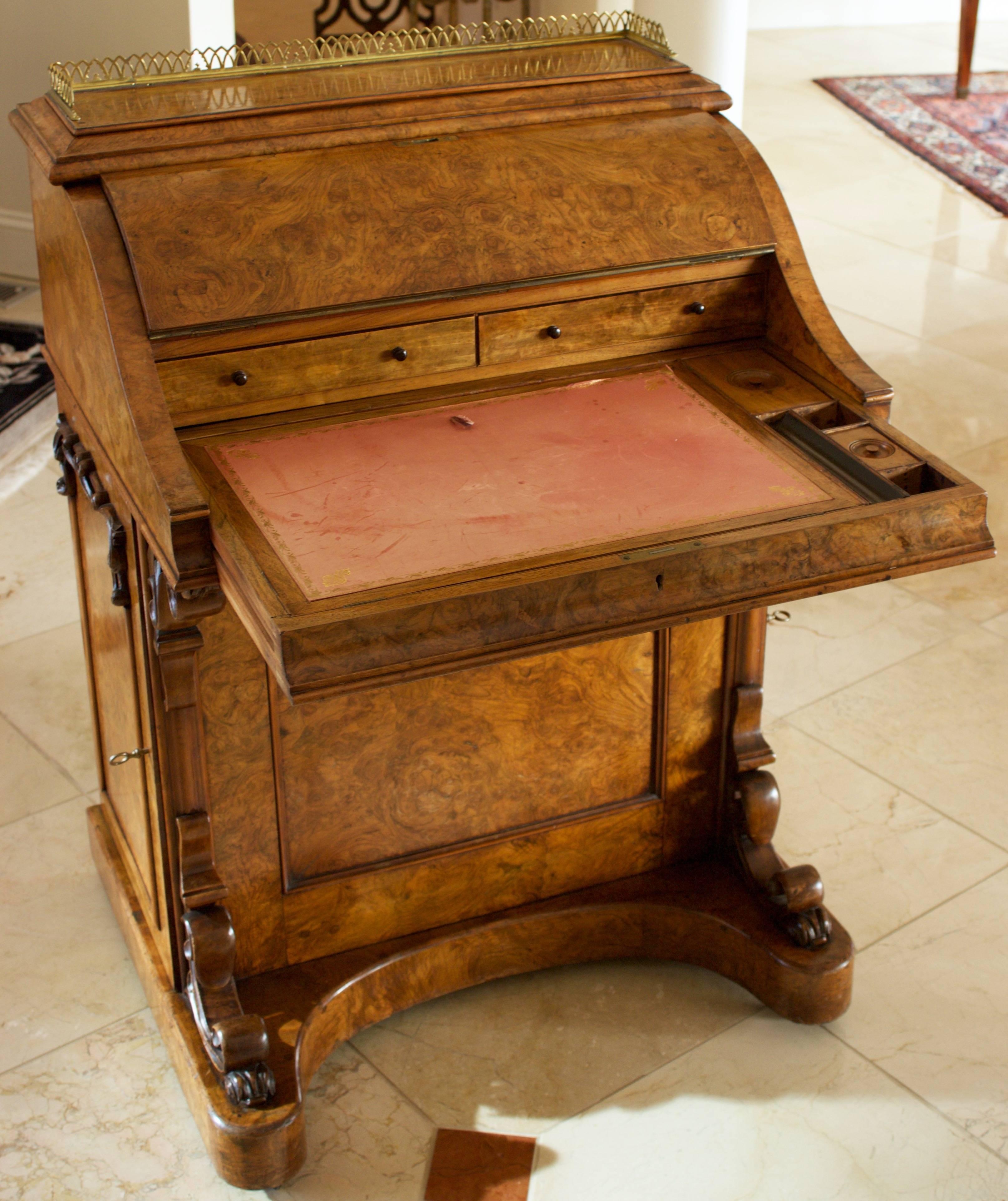 Fabulous Davenport desk from Victorian era in very rare burr elm. Comes with a pull-out writing slide with a raising tooled red leather writing surface, lidded pen and ink boxes and a secret pin to release a pop-up top revealing two drawers and four