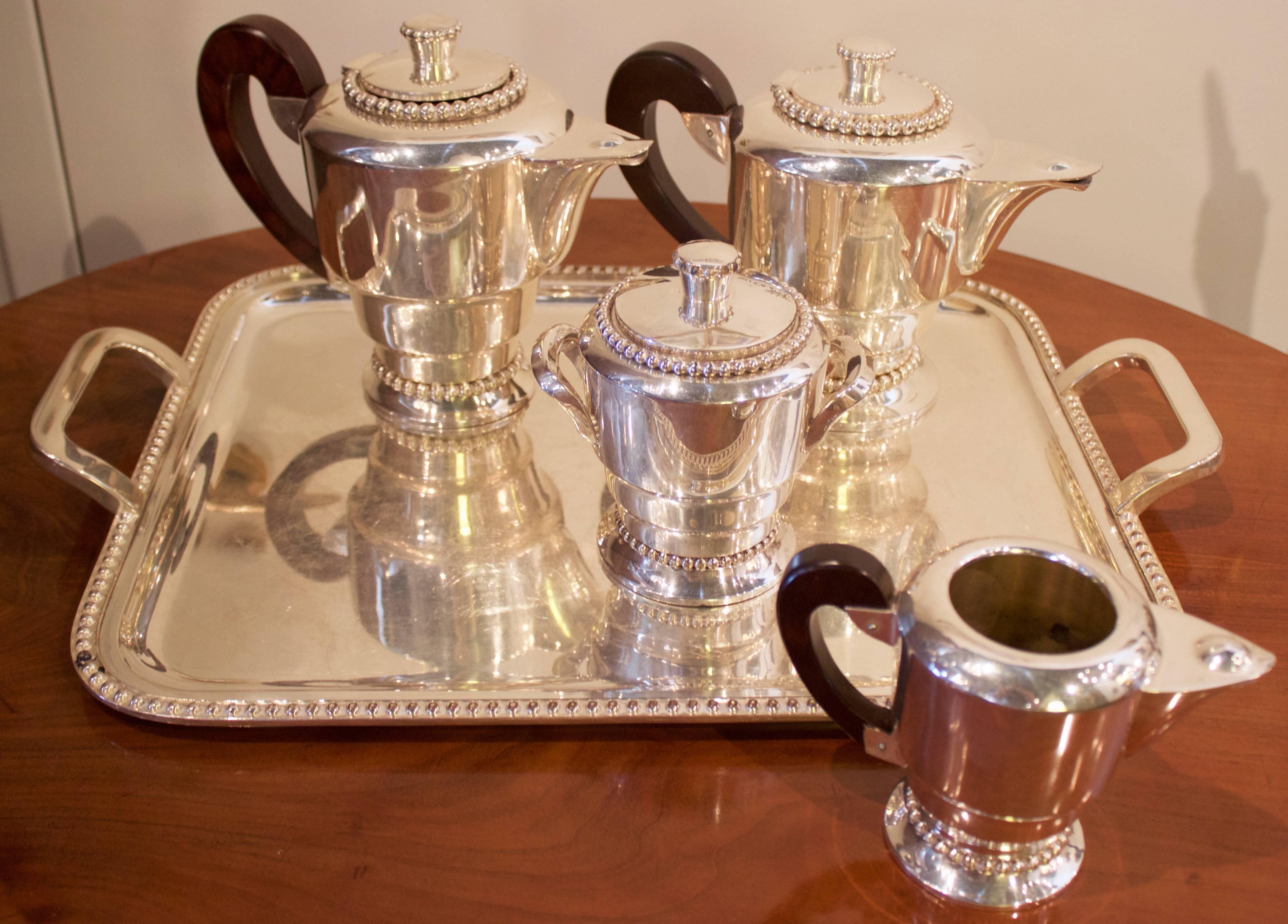 Elegant Art Deco set in Jean Despree Style. Includes teapot, coffee pot, sugar bowl, milk jug and its original tray. Gorgeous wood handles.
Each piece shows a Maker's mark which here is a 