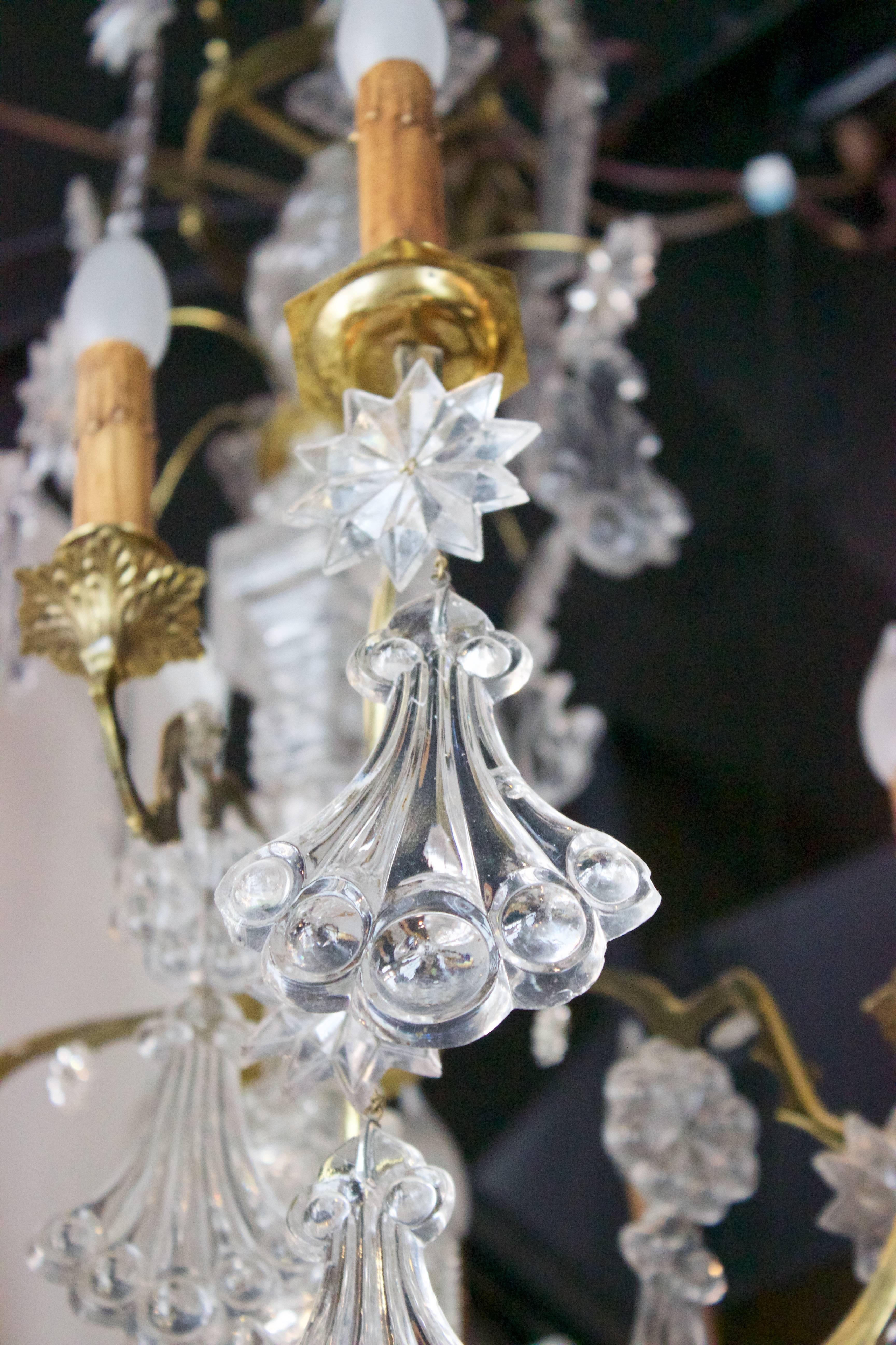 This fabulous Louis XV style chandelier deploys around a bronze metal structure made of stems and forming a central 