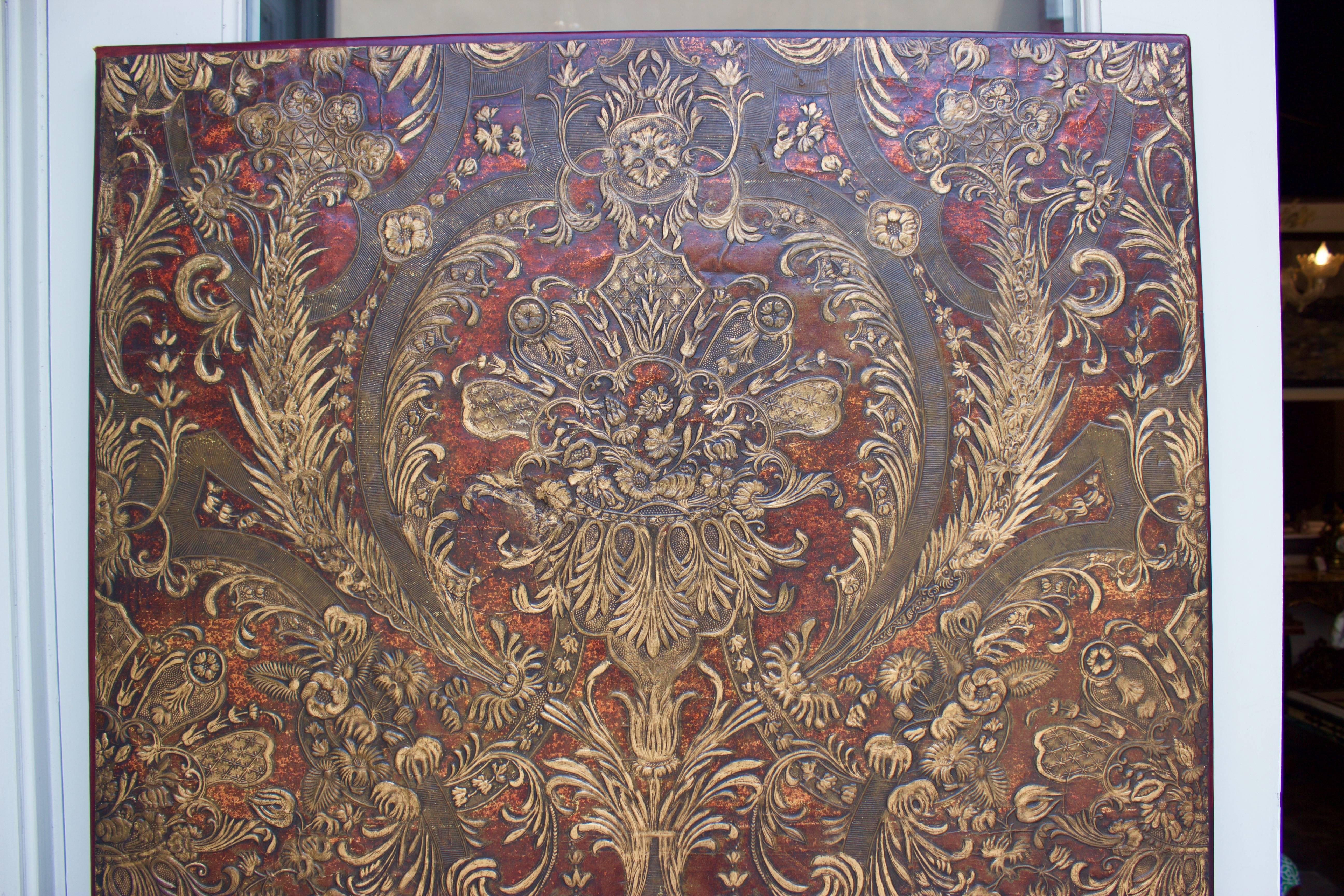 Polychrome and glazed heavy weight pressed paper panel of scrolling floral sprays. Surrounded and backed by a wood frame. Was one of three panels forming a screen.