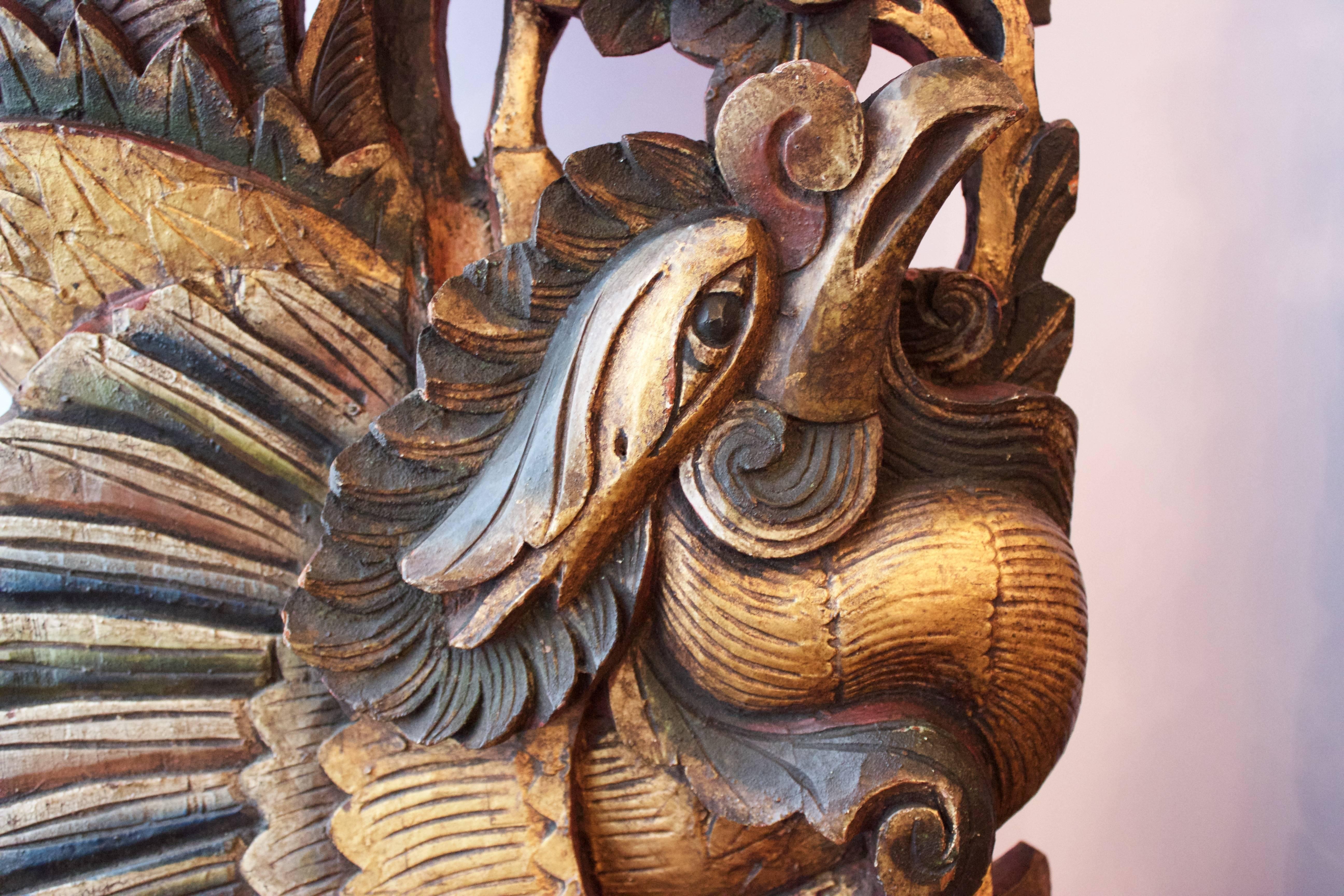 This pair of colorful and extraordinary roosters were hand-carved from single wood blocks, gilded and painted as Architectural elements of homes. Each rooster, surrounded by flowers and leaves shows-off its polychrome magnificent feathers and sort