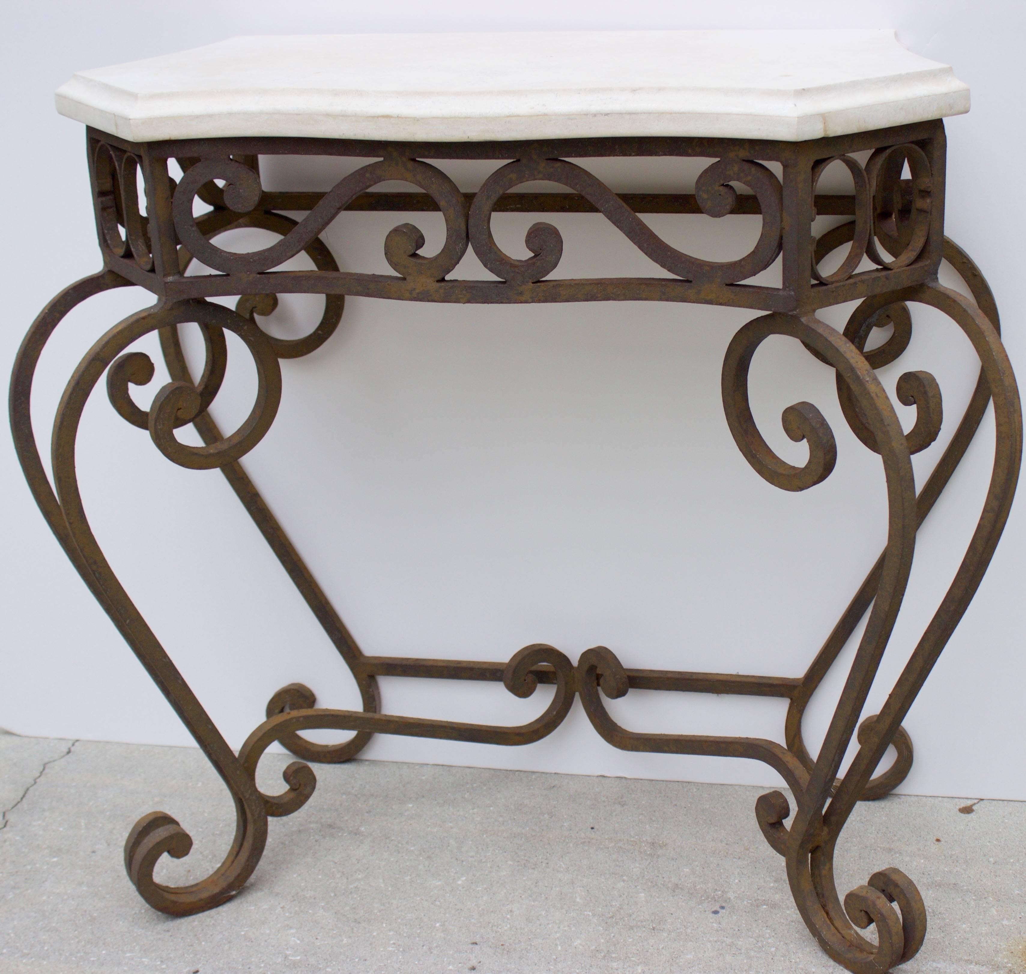 Simple but elegant serpentine wrought iron console with a serpentine beveled travertine top. 
