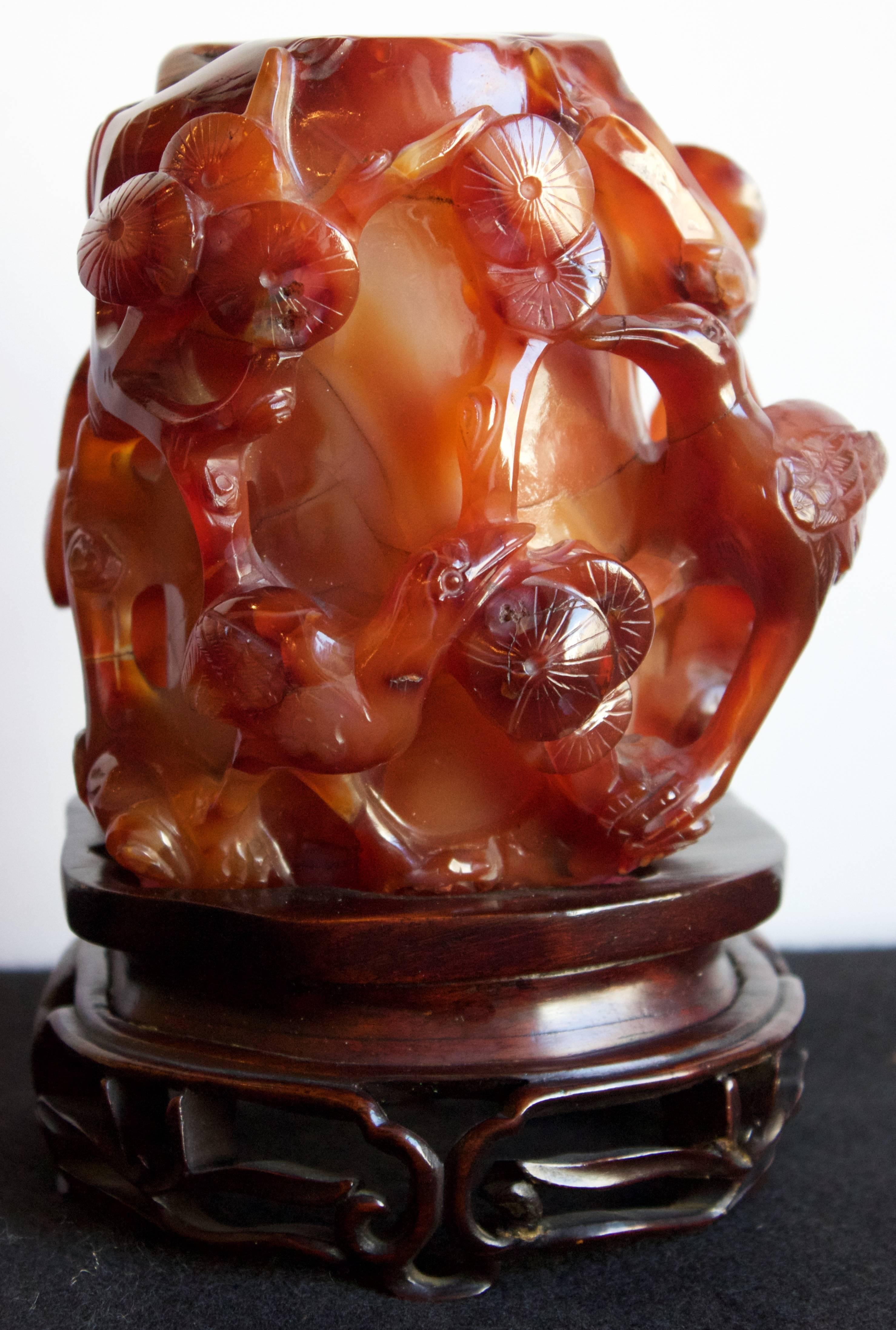 This hand-carved brush pot has a deep cylinder well in its center as a container fot calligraphy brushes in a scholar's studio. Entirely made of red orange Carnelian agate (considered as the energy of blood) it is decorated with carved cranes and