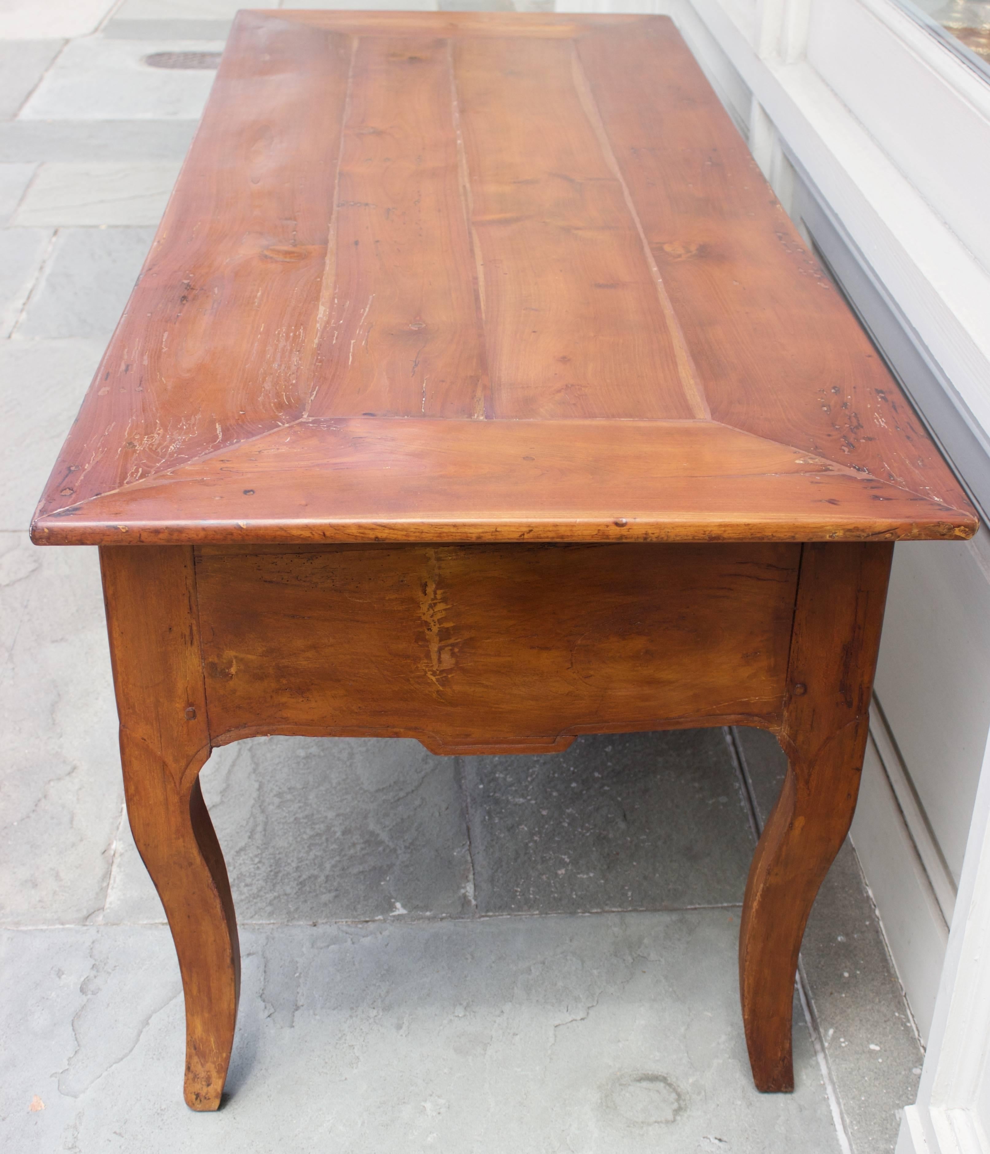 Interesting large desk in Louis XV style made early 19th century. Entirely in cherrywood. The construction of its top is called 