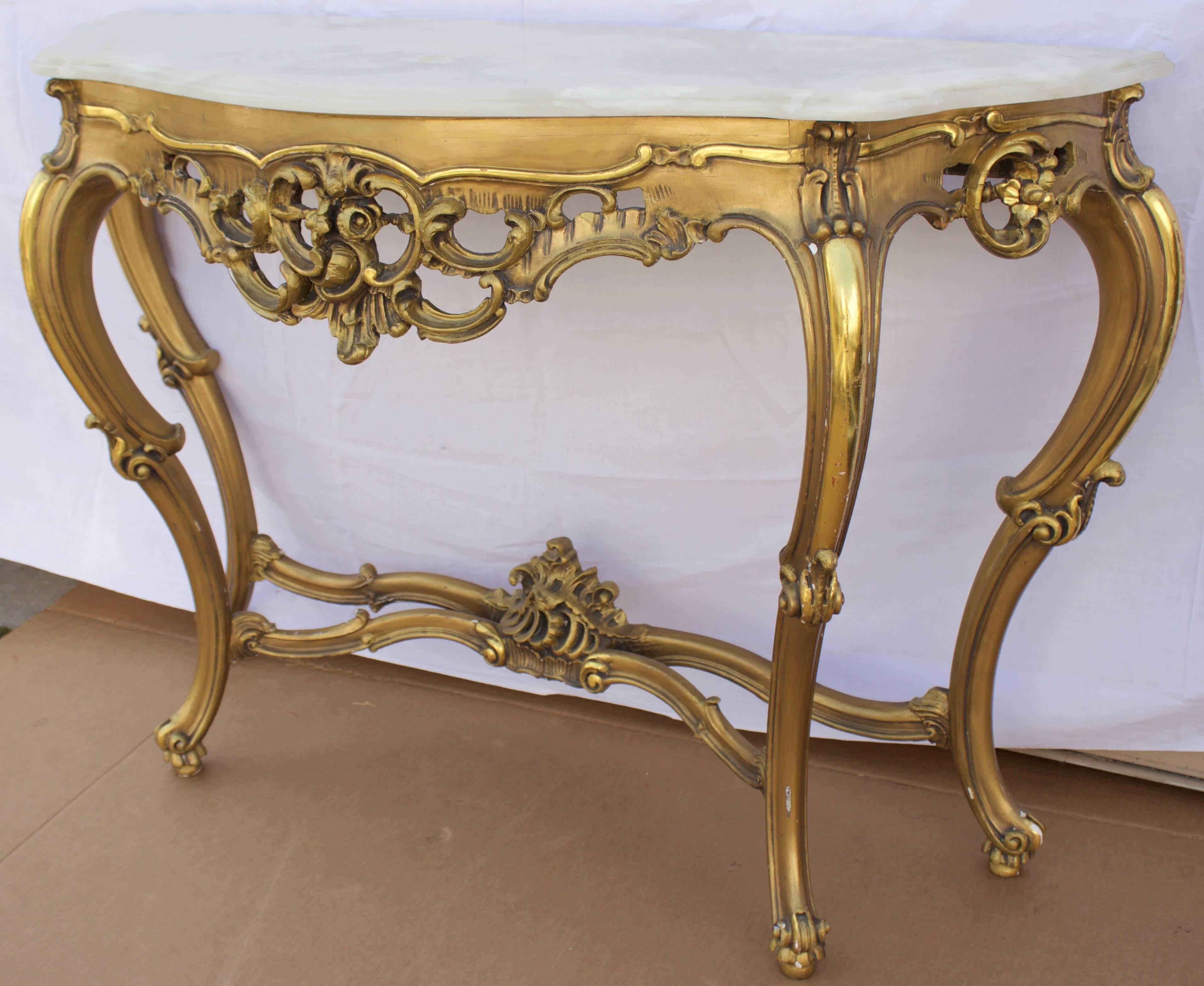 Attractive Louis XV style console in a shaped alabaster top over gilt frame, pierced skirt and scrolled legs.