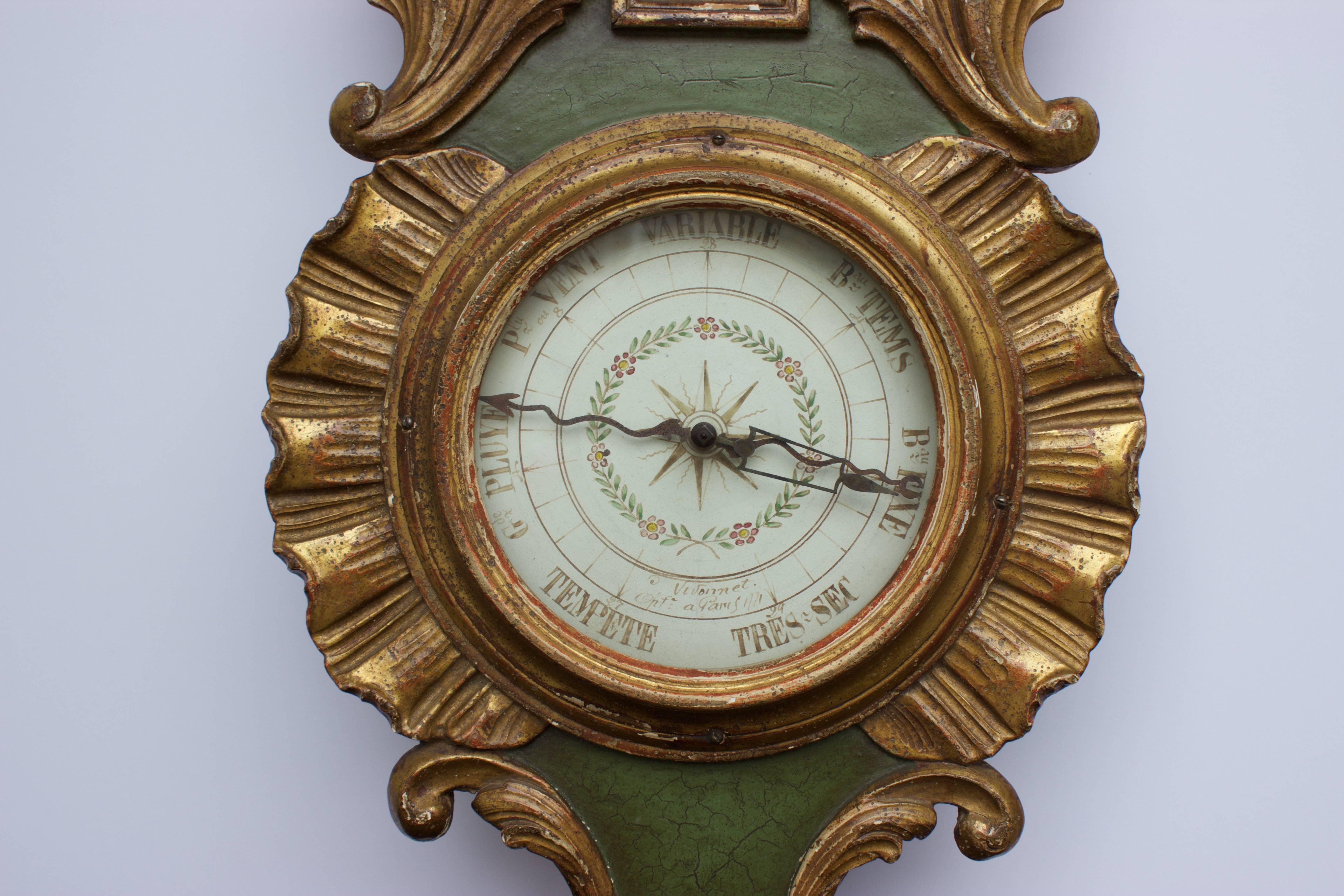 Extremely deco barometer and thermometer in carved and gilded wood acanthus leaves. The barometer face is protected by a glass globe and set within a decor of carved and gilded 