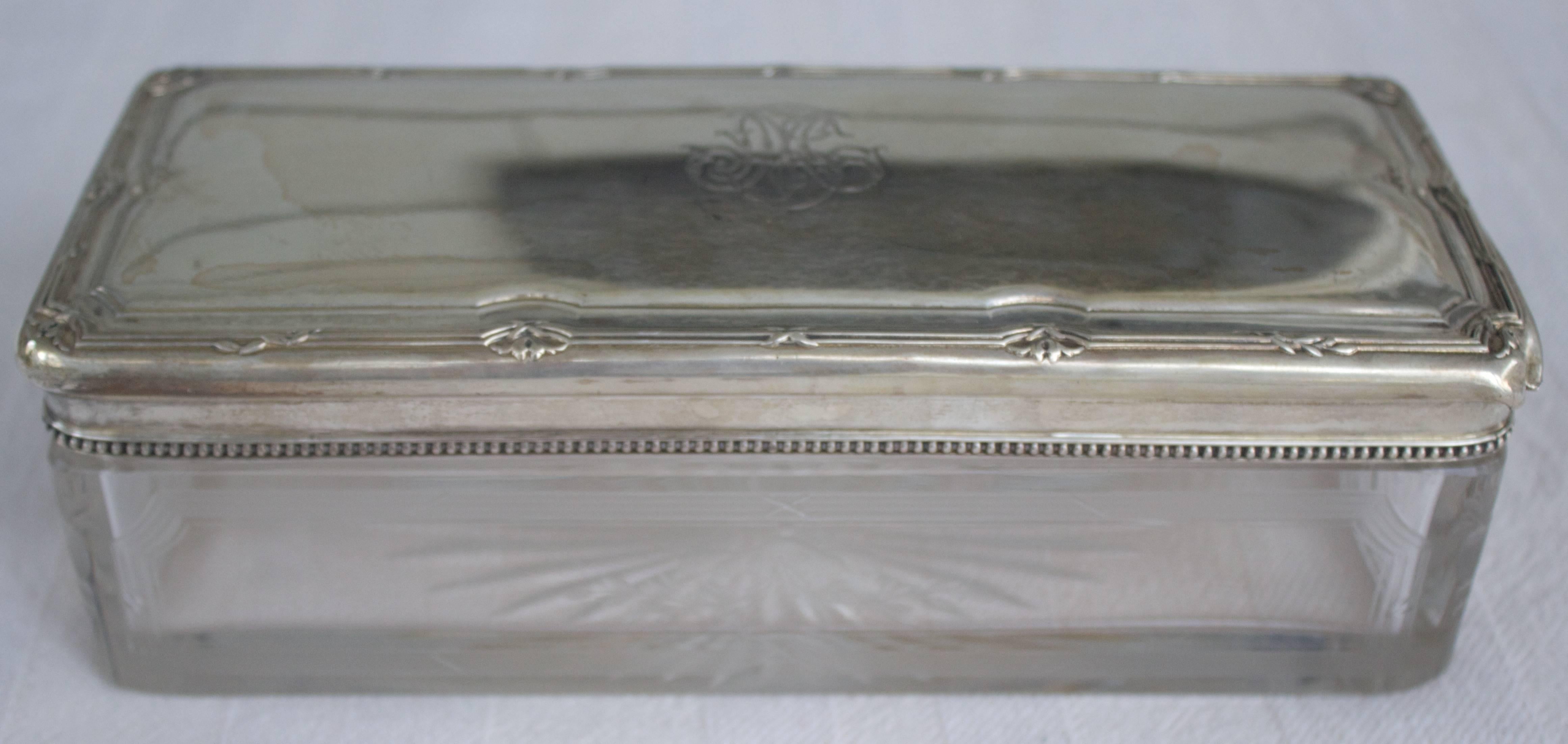 Rectangular casket in engraved crystal body with silver top monogrammed and chased on top.
A great gift!
