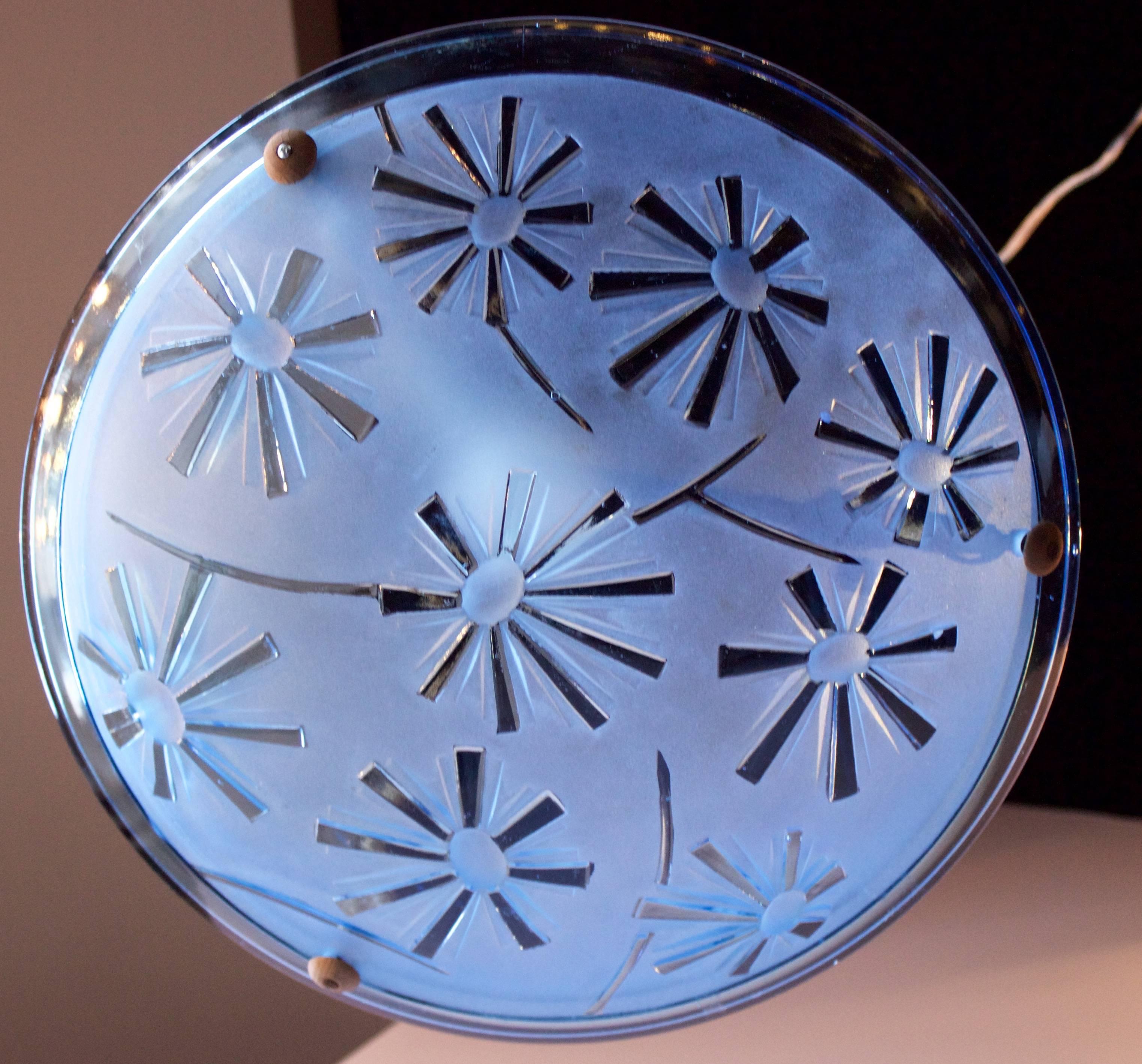 Skyblue thick molded glass pendant with a pressed geometric pattern like sunrays on the convex side .Silk covered original fixtures. Rewired for the USA with a single central bulb. Marked 