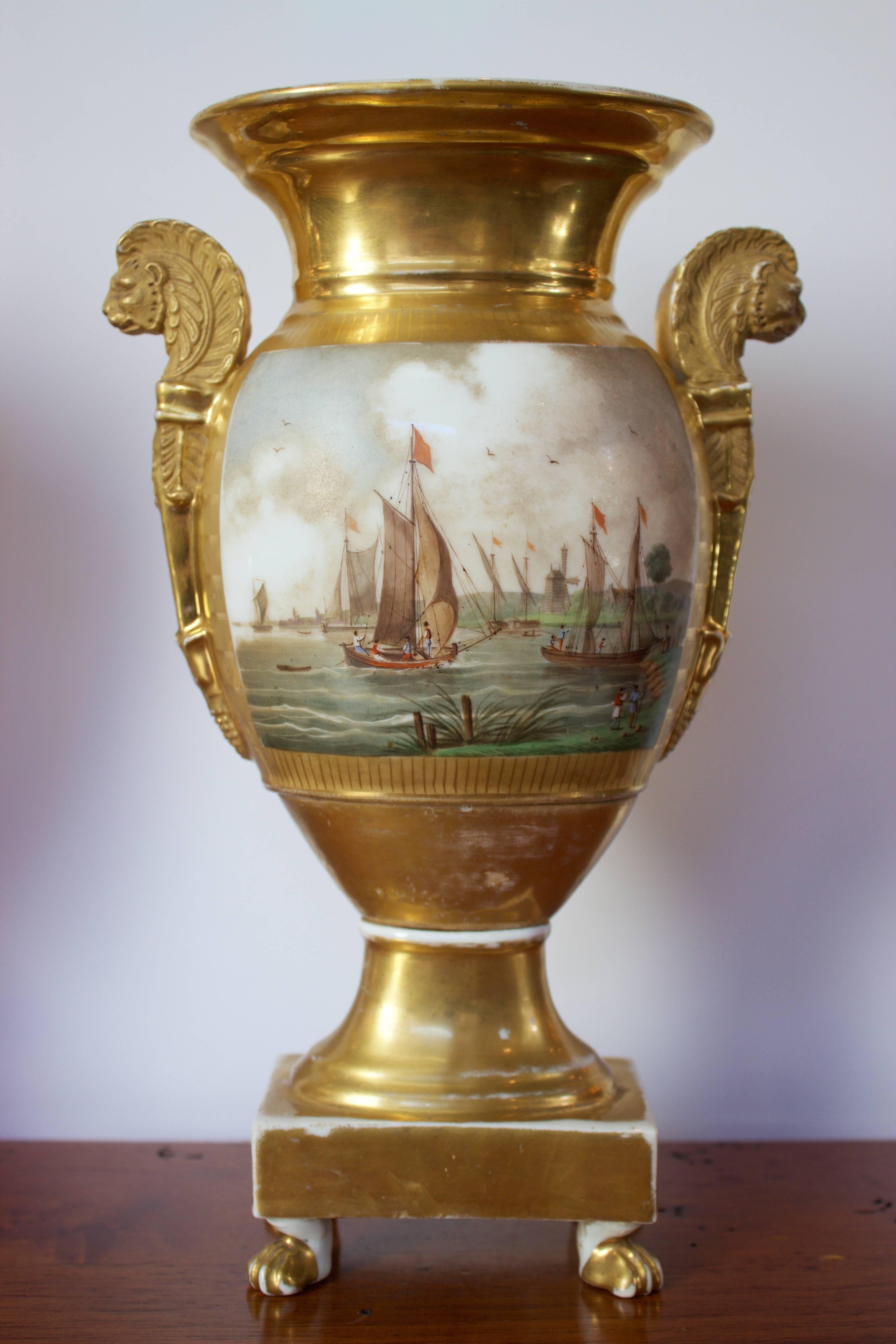 Truly beautiful pair of white porcelain vases from the Empire period .The main face of each vase is decorated by gorgeous hand-painted seascapes representing sailboats on the ocean and near the coast. These large painted cartouches are outlined by