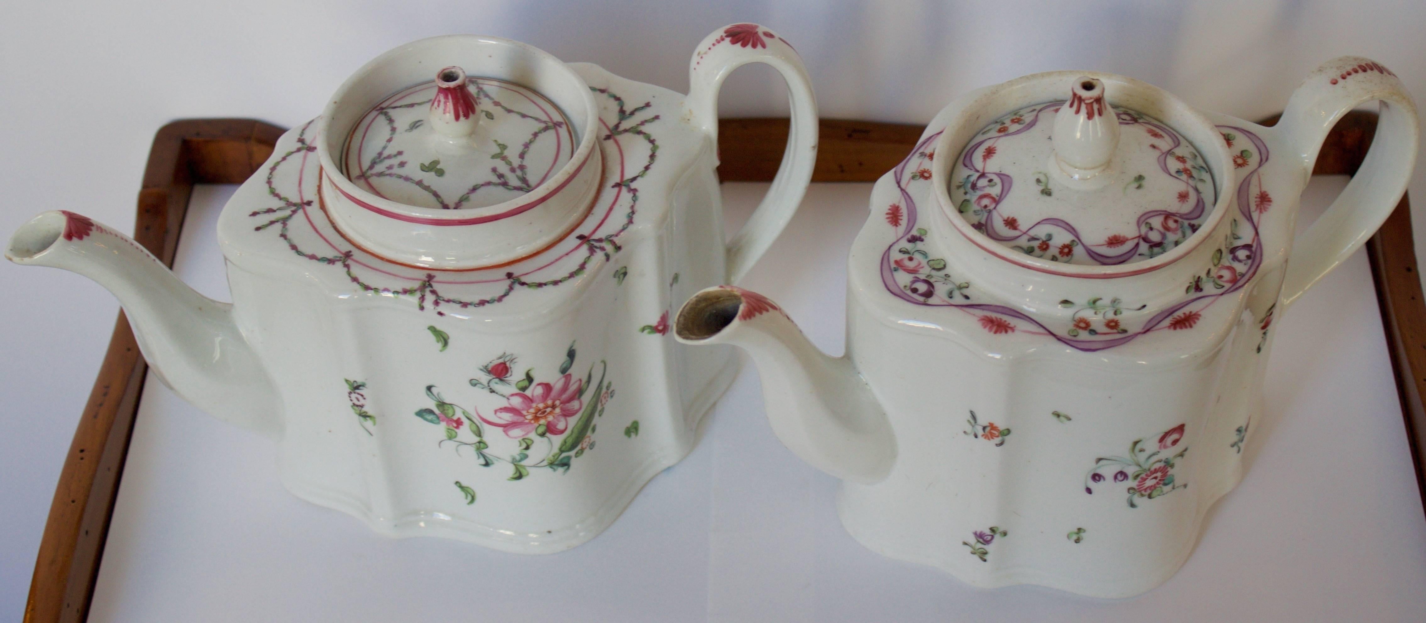 Lovely pair of antique 18th century. Teapots probably from Luneville. Handmade and painted with their lovely and delicate floral parers and venter tops. Perfect for a spring table.