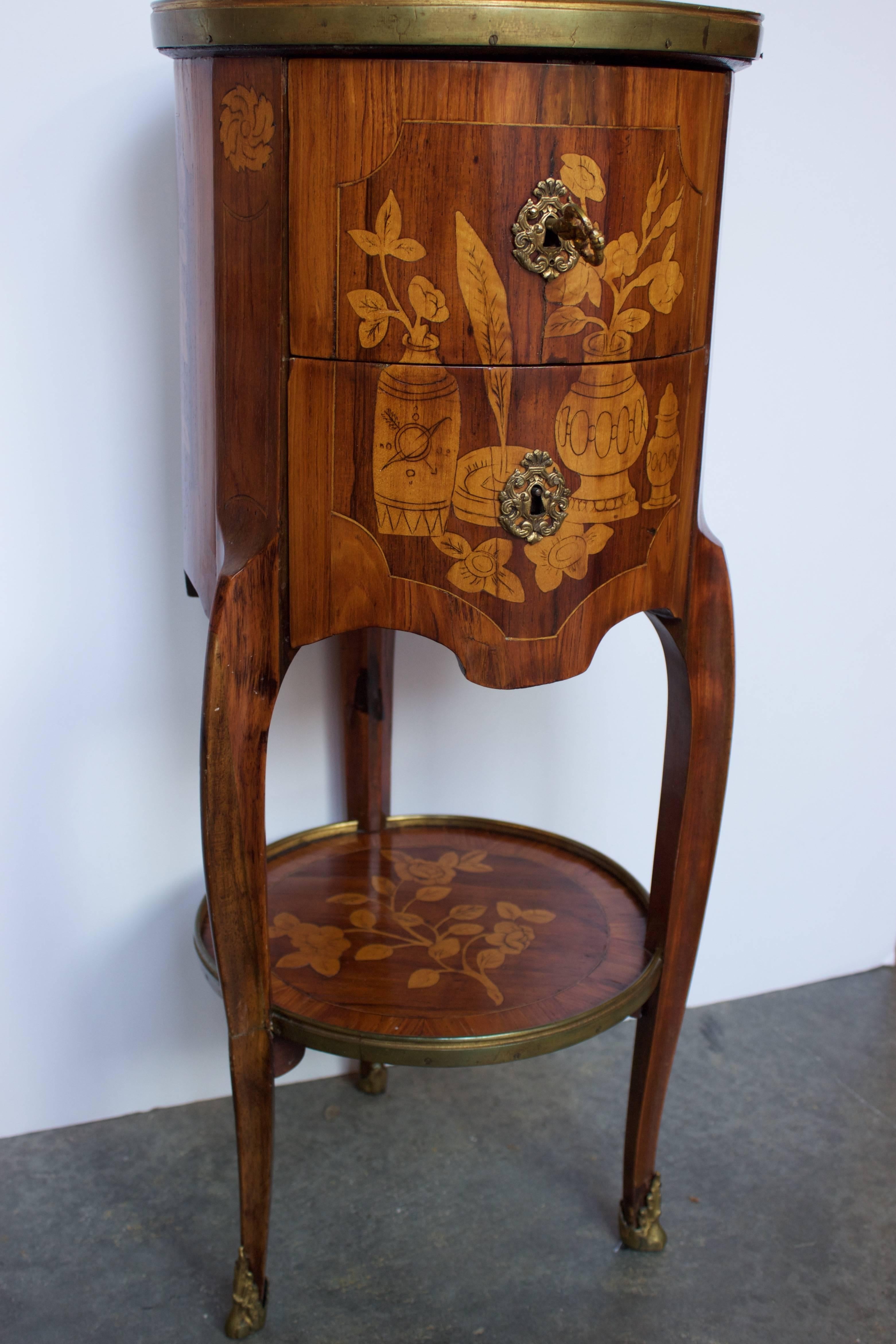 Delightfull side table called Tambour (Drum) due to its round shape. Marquetry on all faces- as well as lower shelf- representing small vases, flowers, inkwell with its feather in mahogany, sycamore and Kingwood veneering on oak. Attributed to