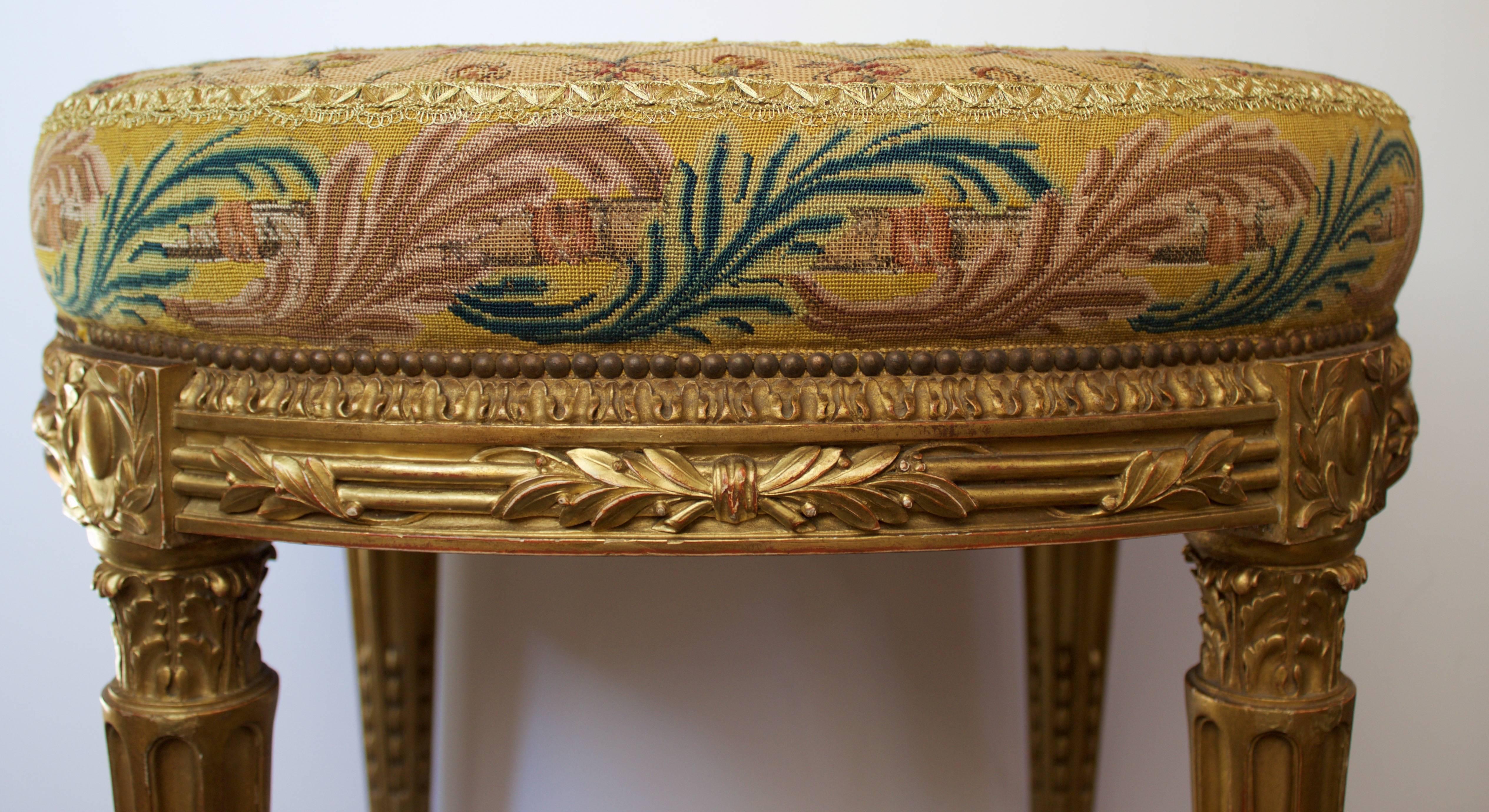Gorgeous stool in carved and gold gilded wood with an oval seat covered with the original beautiful tapestry done 