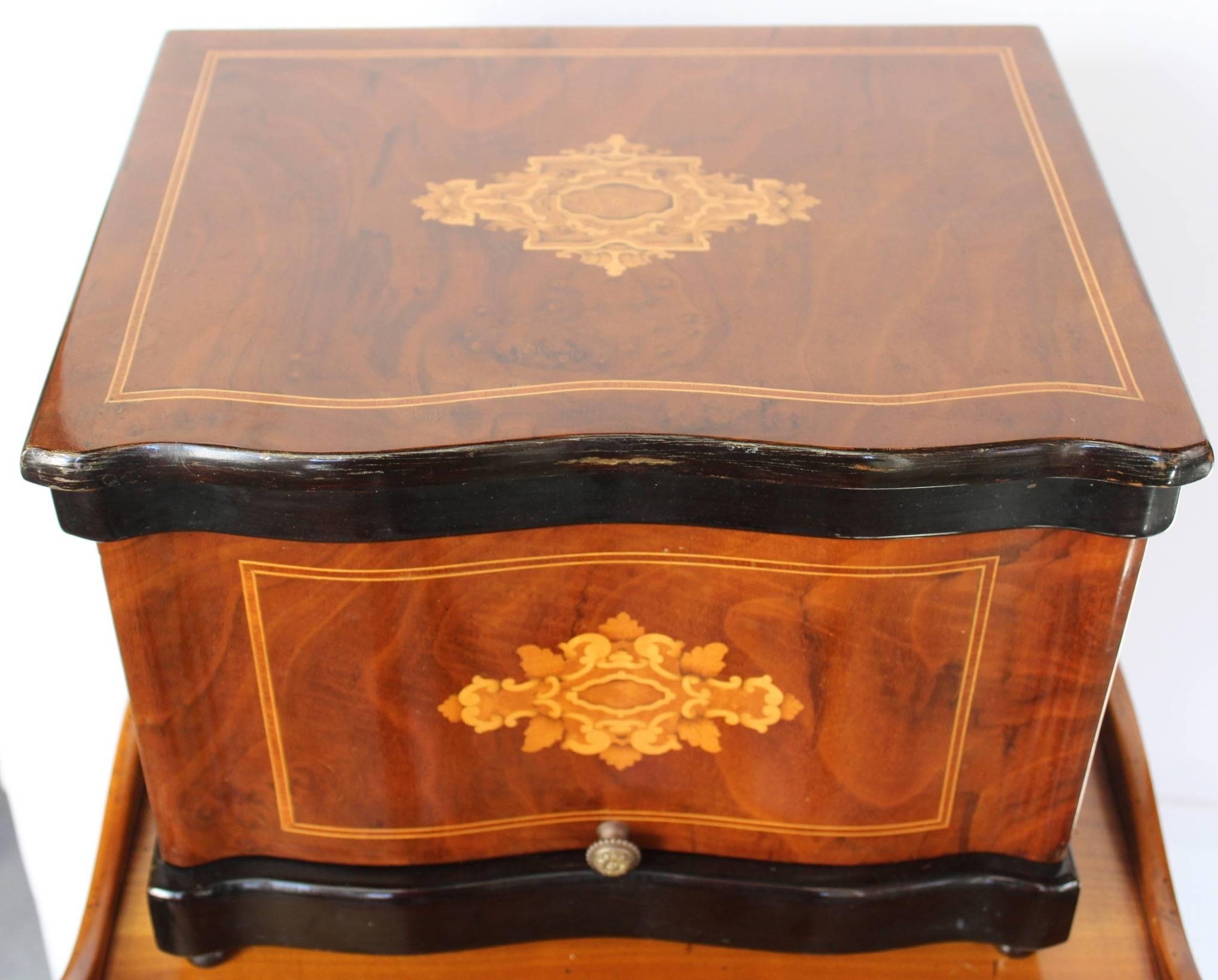 Fine Napoleon III period  Cave a Liqueurs. Case of mahogany veneer with a marquetry of Blonde wood on top and in front and an ebonized wood band top and bottom.The lid lifts upward ,allowing the sides to open for an easy access and revealing a two