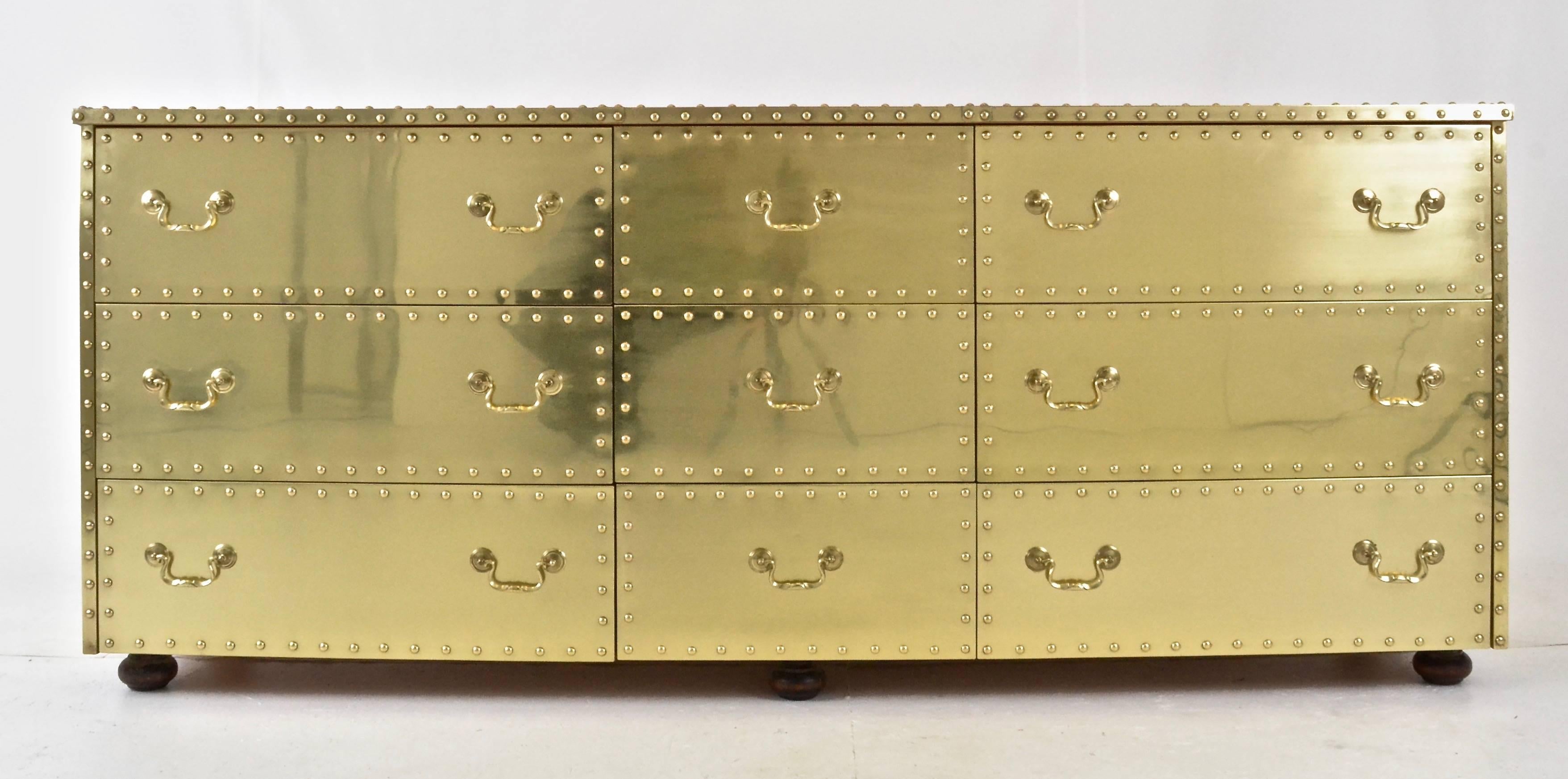 A nice clean example of the Sarreid brass-clad dresser with non drawers. Clad on three sides with solid brass sheeting and nail-head decoration. Very glam!