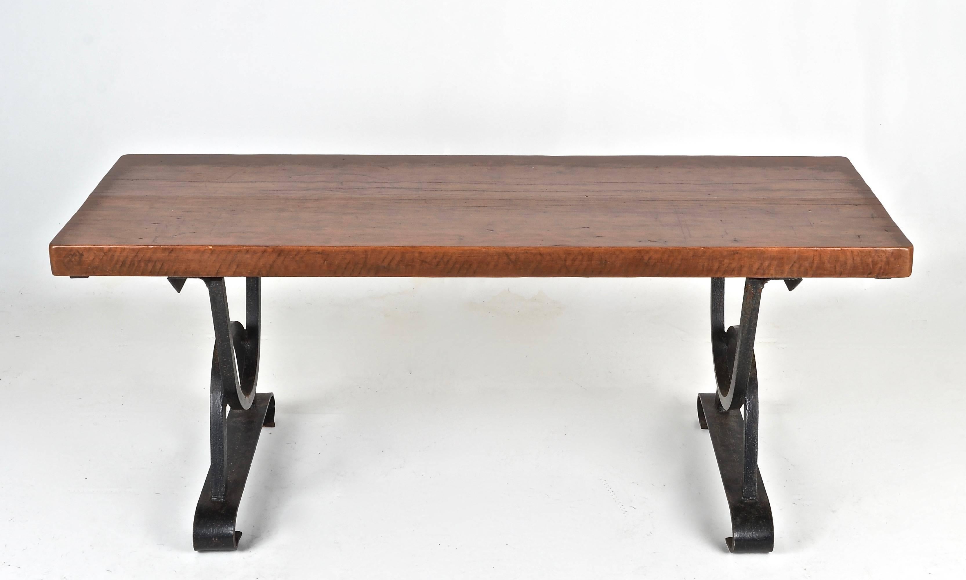 Super fine quality bench or table, made in France, circa 1960s. Heavy iron base with thick oak top. Lovely patina and color.