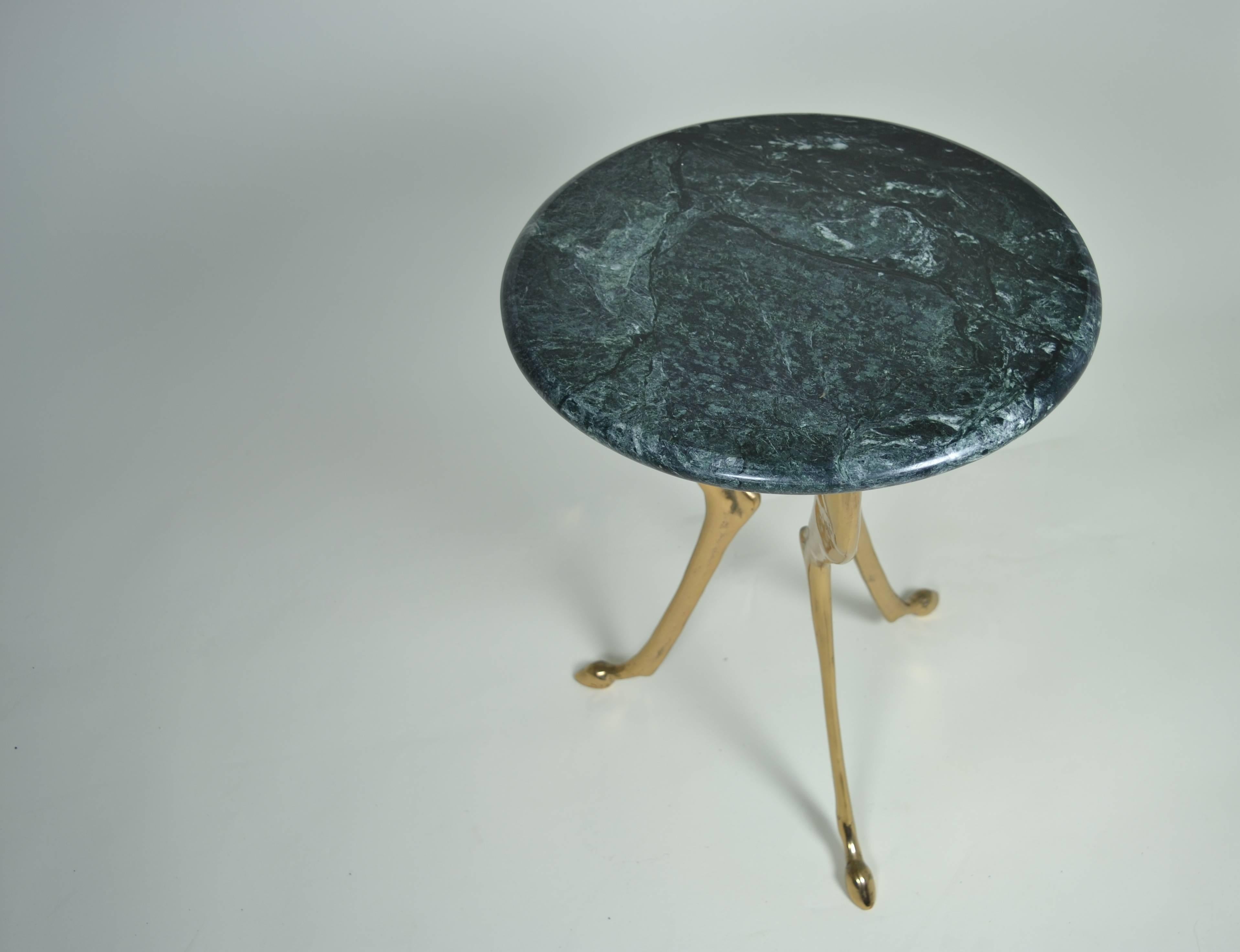 Super quality and great design in a small elegant table. Heavy, solid brass legs support a fine marble-top in dark green with subtle veining.