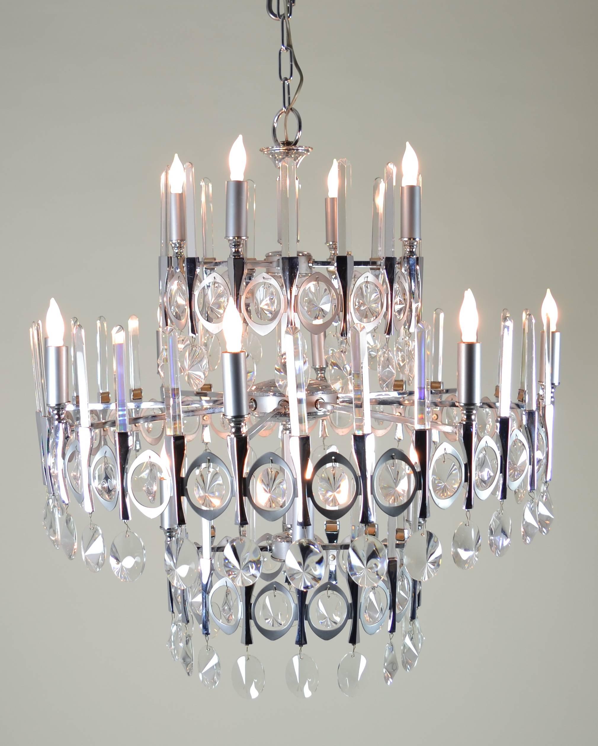 Sixteen-light round chandelier with crystal pendants and fixed crystal rods on three levels. Very dramatic in excellent condition and comes with extra crystals of each size/form. Wiring has been checked and confirmed to be sound, newly cleaned.