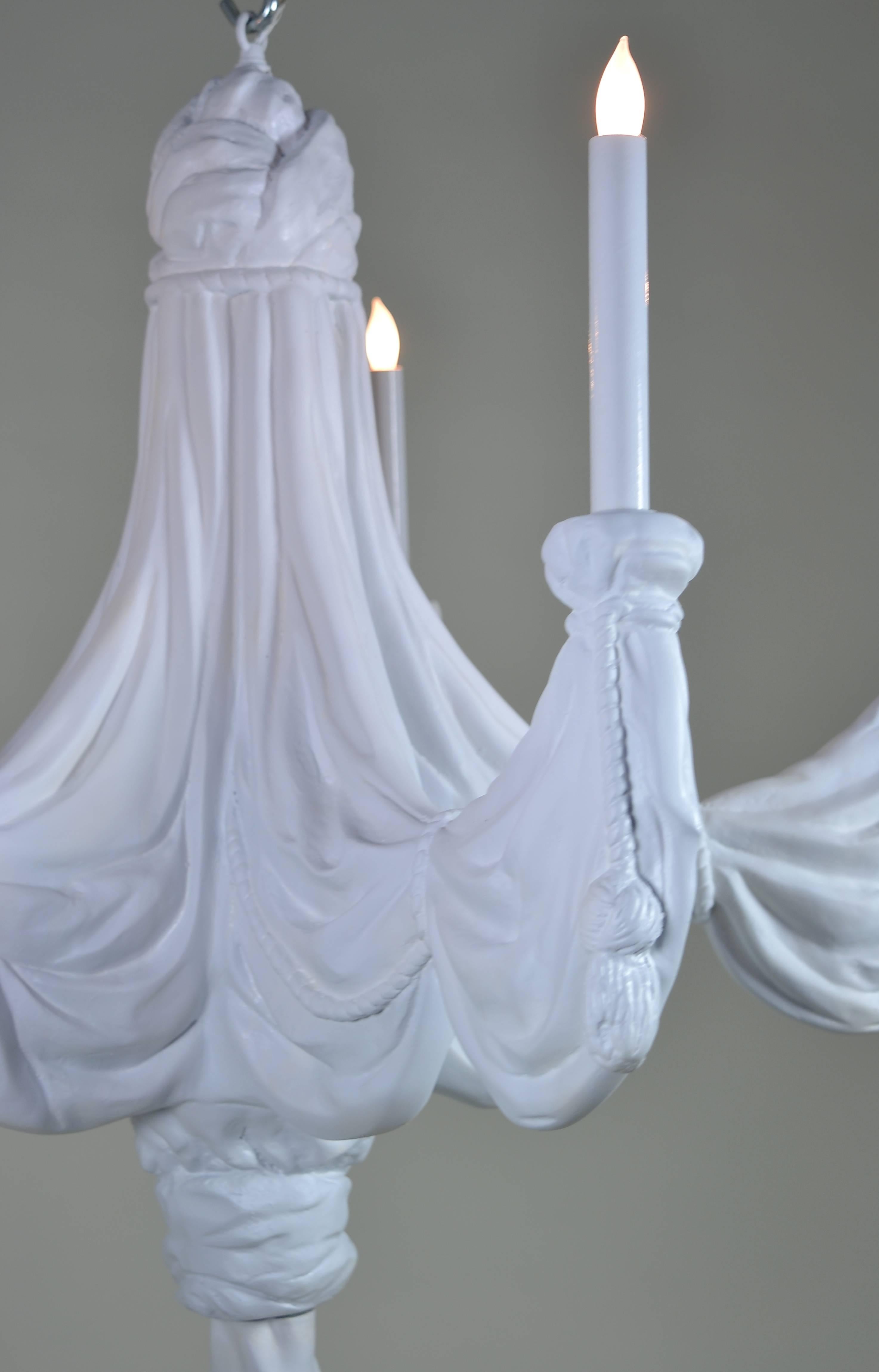 Classical draped fabric design, one of Sirmos Lighting's most iconic designs. Five lighted arms, in quality resin with matte white plaster-like finish.