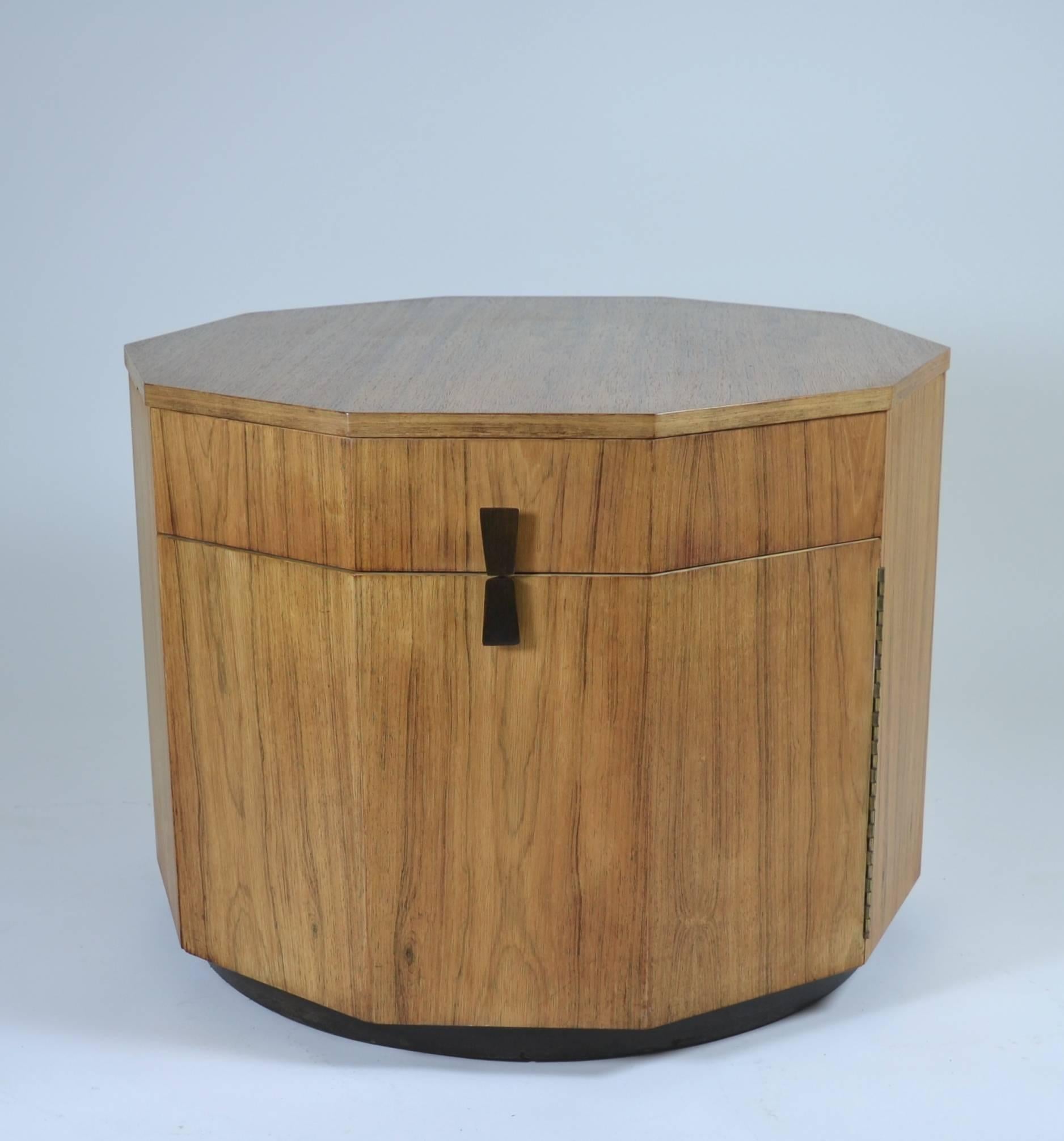 This blonde rosewood example of Harvey Probber's Classic Decagon table is the largest size, at 30" x 22.5". Originally created as a dry bar, it features a bottle shelf on a hanged door and a large storage compartment; also a wide drawer.