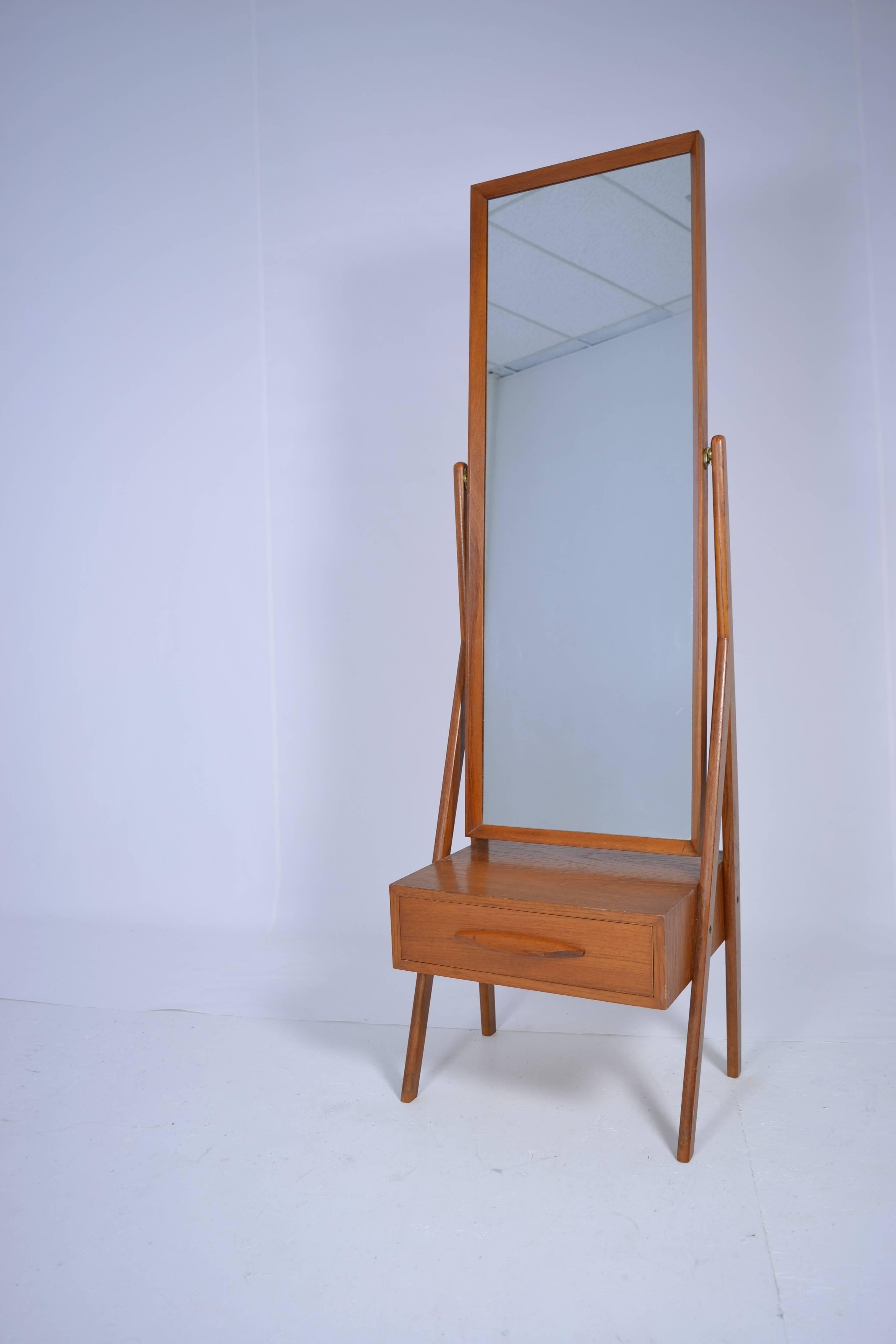 Teakwood mirror on stand with single drawer beneath. Marked "Made in Denmark." Great form and size.