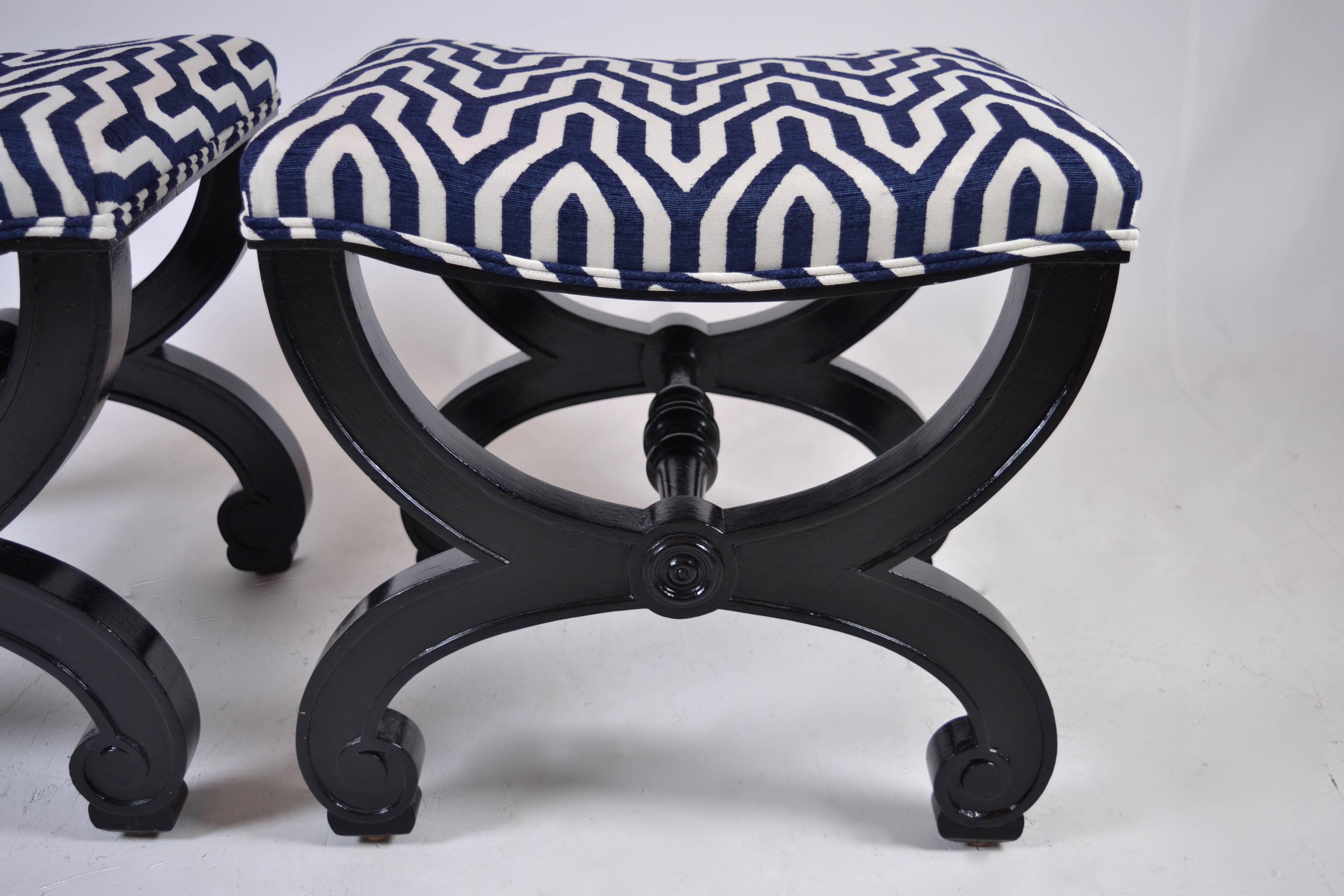 A handsome pair with black painted base and new upholstery in dark, dark blue and white.