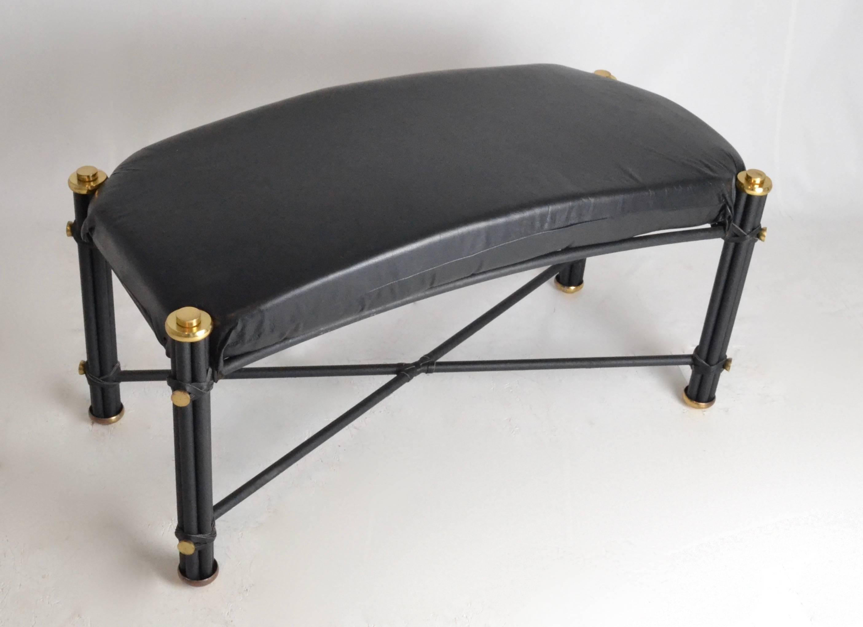 Quality construction and great attention to design, an iron bench with black textured finish. Wrapped leather thong details along with polished brass. Leather covered seat cushion.