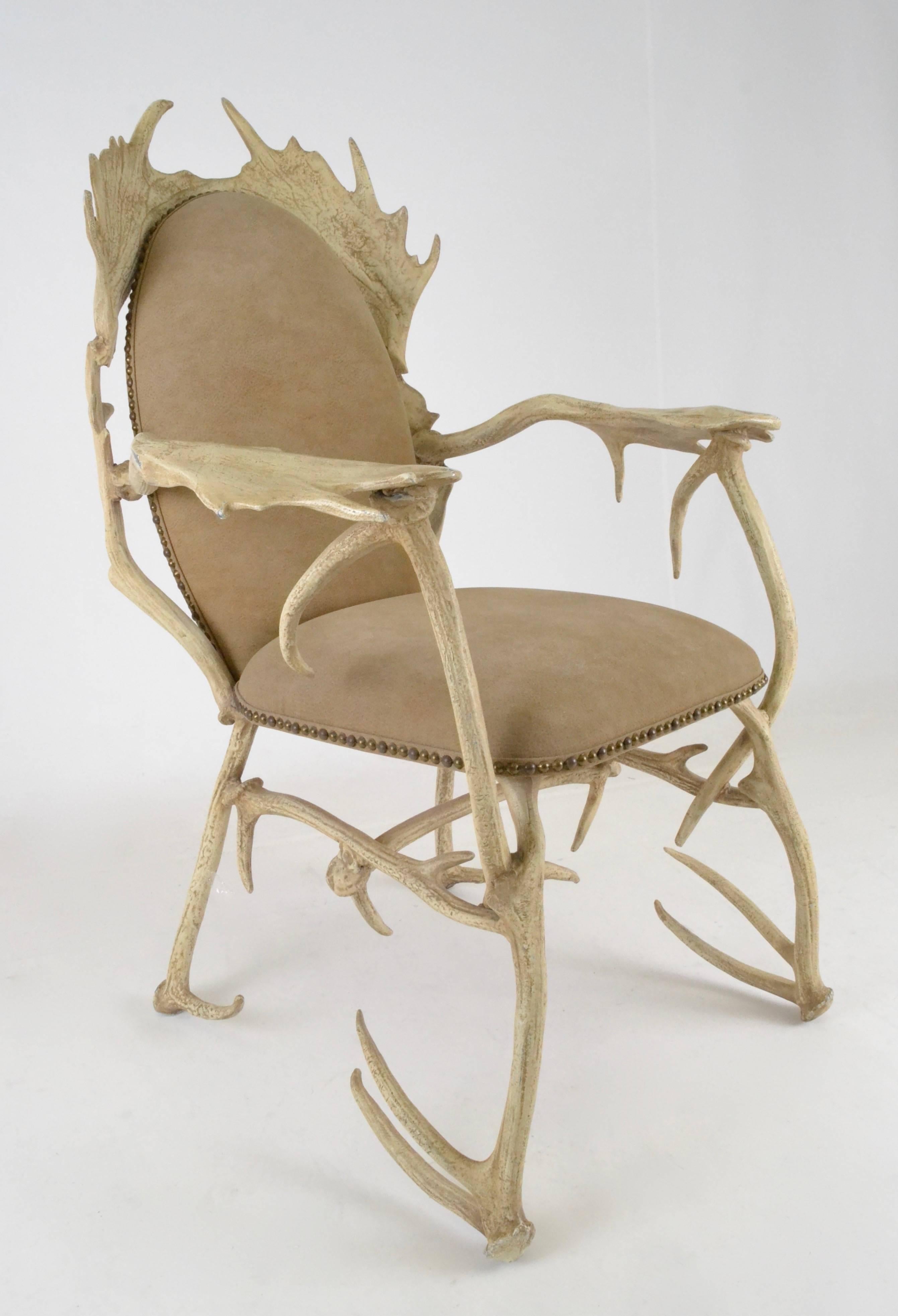 One of the greatest Arthur Court creations so whimsical and yet perfectly usably. Quite comfortable and very sturdy. Made of cast aluminum, painted to appear as natural antlers. Original faux suede upholstery with nail head detail is clean. Makers
