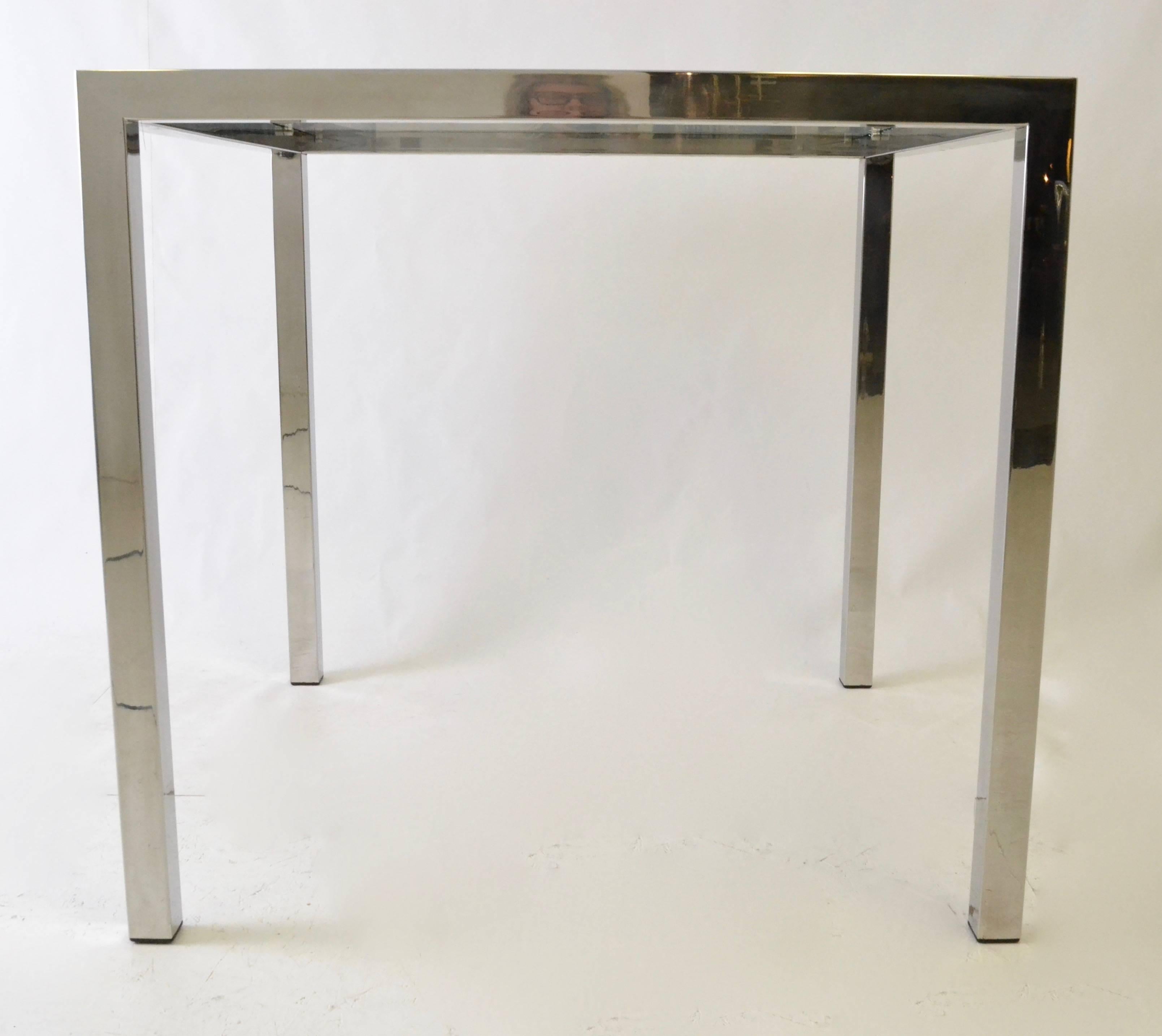 A sleek and simple square table. Great game table. Glass is new and in excellent condition. The chrome has been newly polished and is very good on top and the upper part of legs. Minor scratches low on legs (vacuum bites).