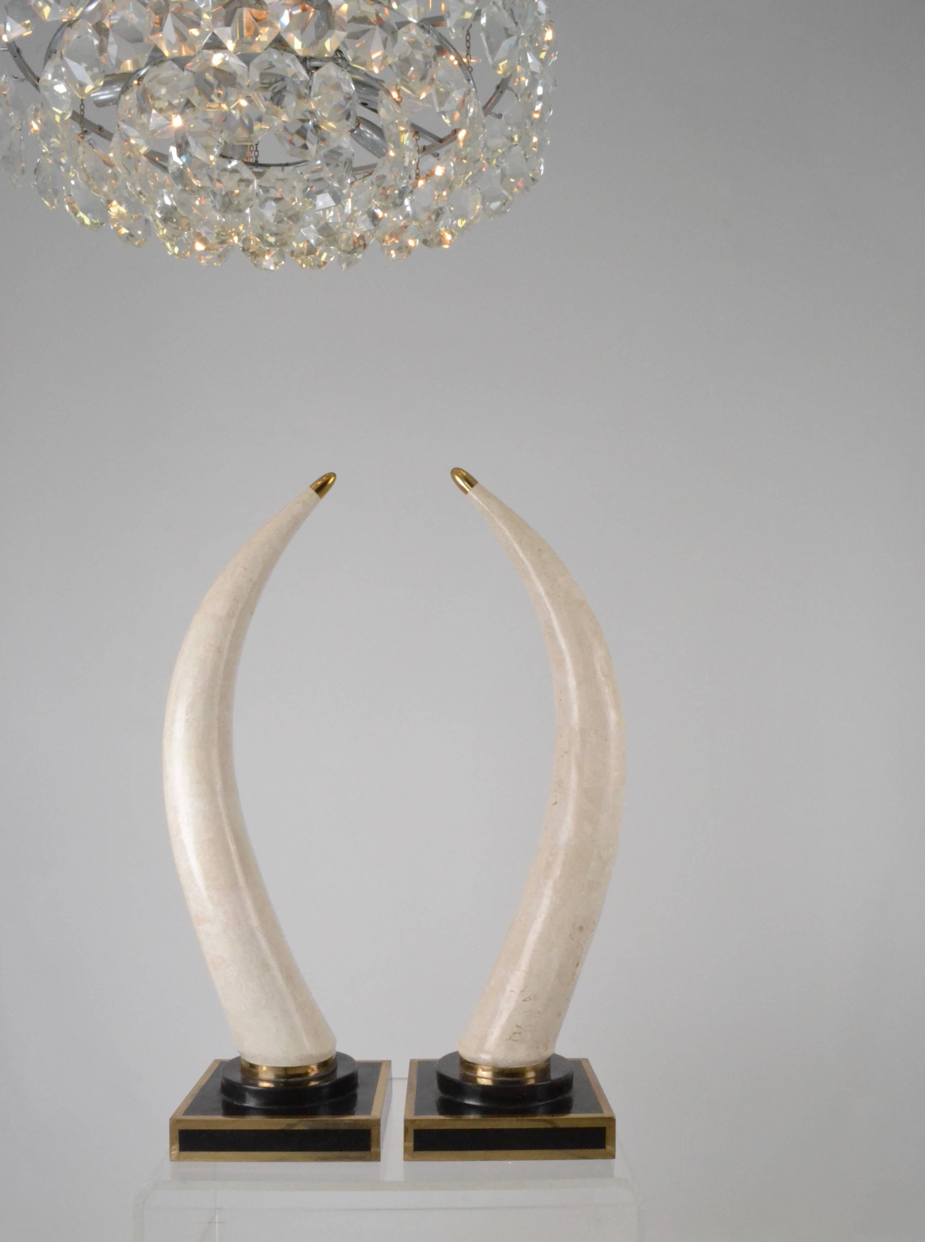 So glam! Hollywood Regency-style tessellated marble tusks. This pair is almost three feet high, dramatic and impressive. Very fine condition with original Beverly Hills retailer stickers on bottom.
