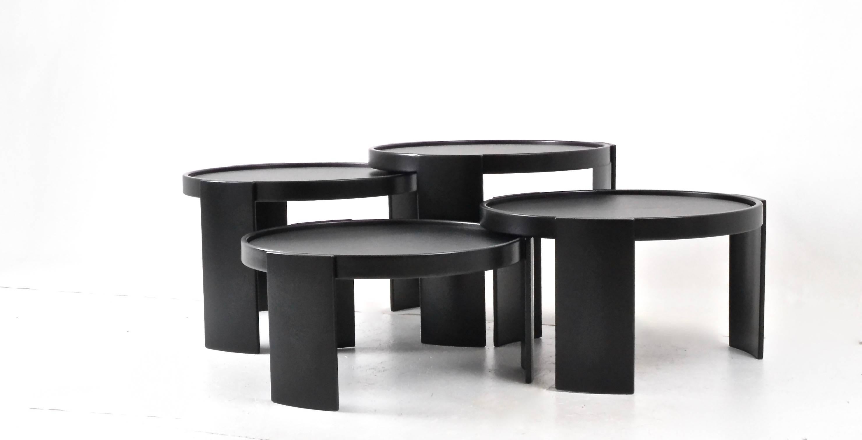 Beautifully restored early set of Cassina nesting tables --a Classic design that may be grouped together in various configurations both horizontally and vertically. There are four tales with interlocking curved legs. This set has the original tops