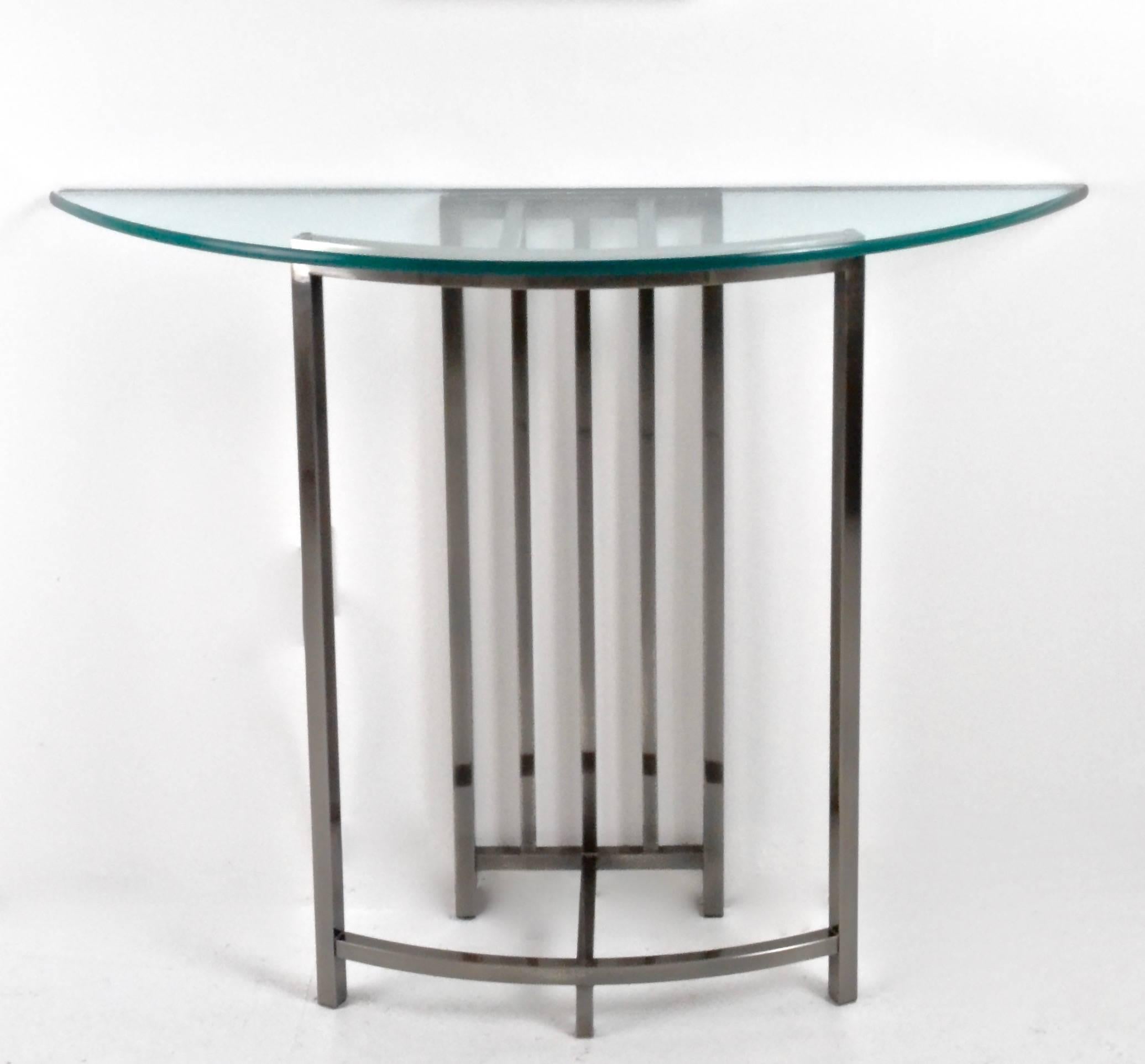 Brushed steel console table with heavy glass top and matching mirror. Mirror features brass ball detail and oriental motif. The console table measures 48