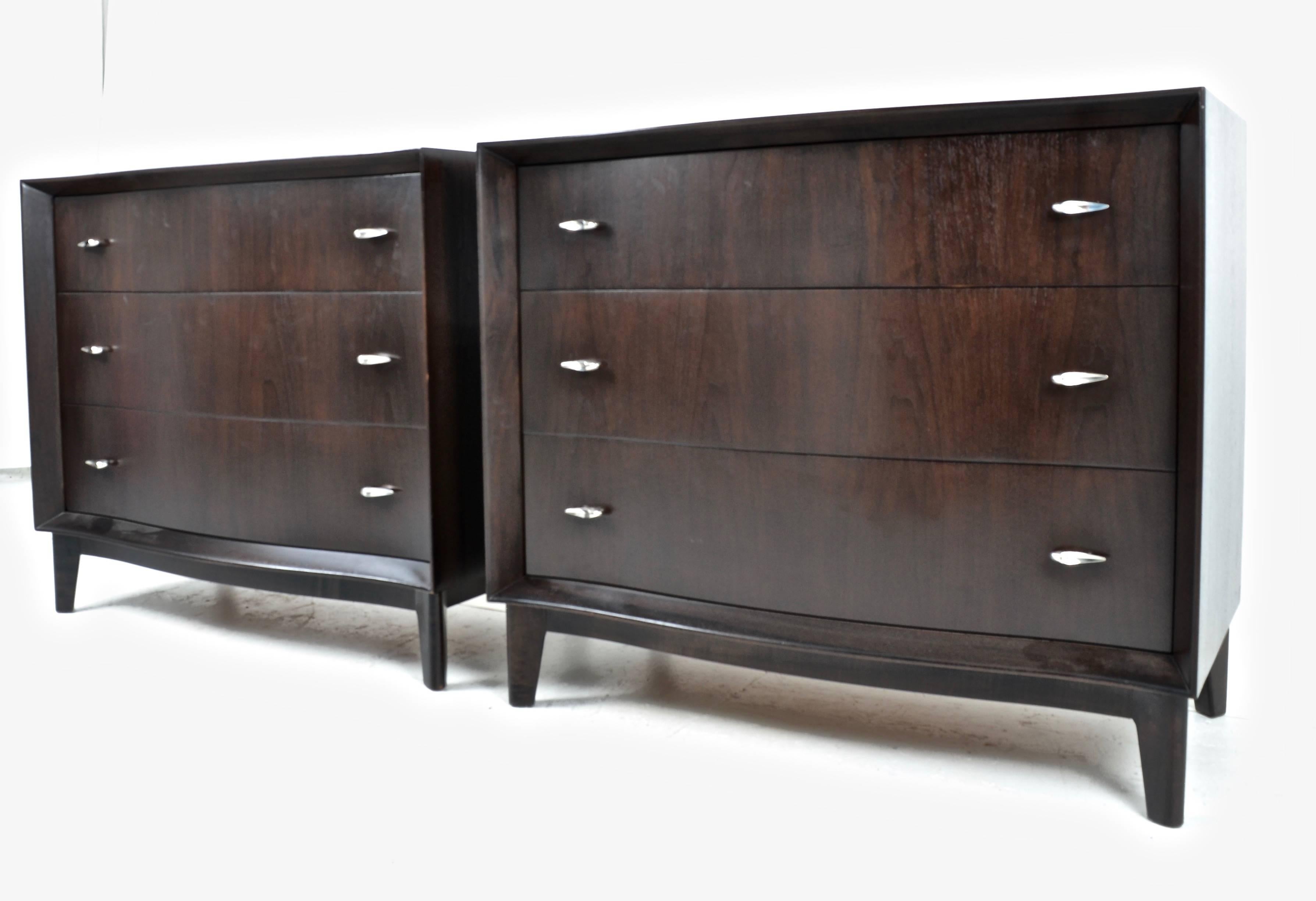 A handsome pair of modern chests in a dark coffee brown finish with original pulls, slightly serpentine with recessed drawers emphasizing flanged edge detail. Newly refinished.