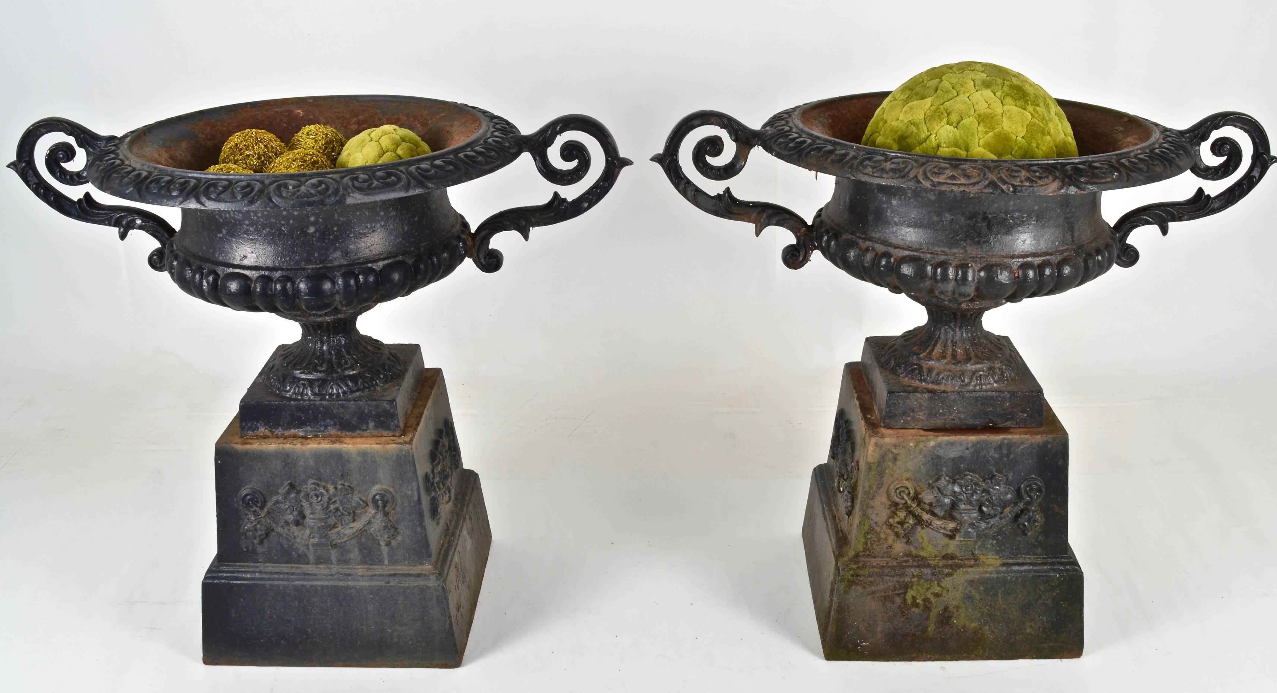Classic Victorian design urns. Great quality in fine vintage condition. Each piece separates into two parts: base and urn for easier transport. Attractive patina on black paint.