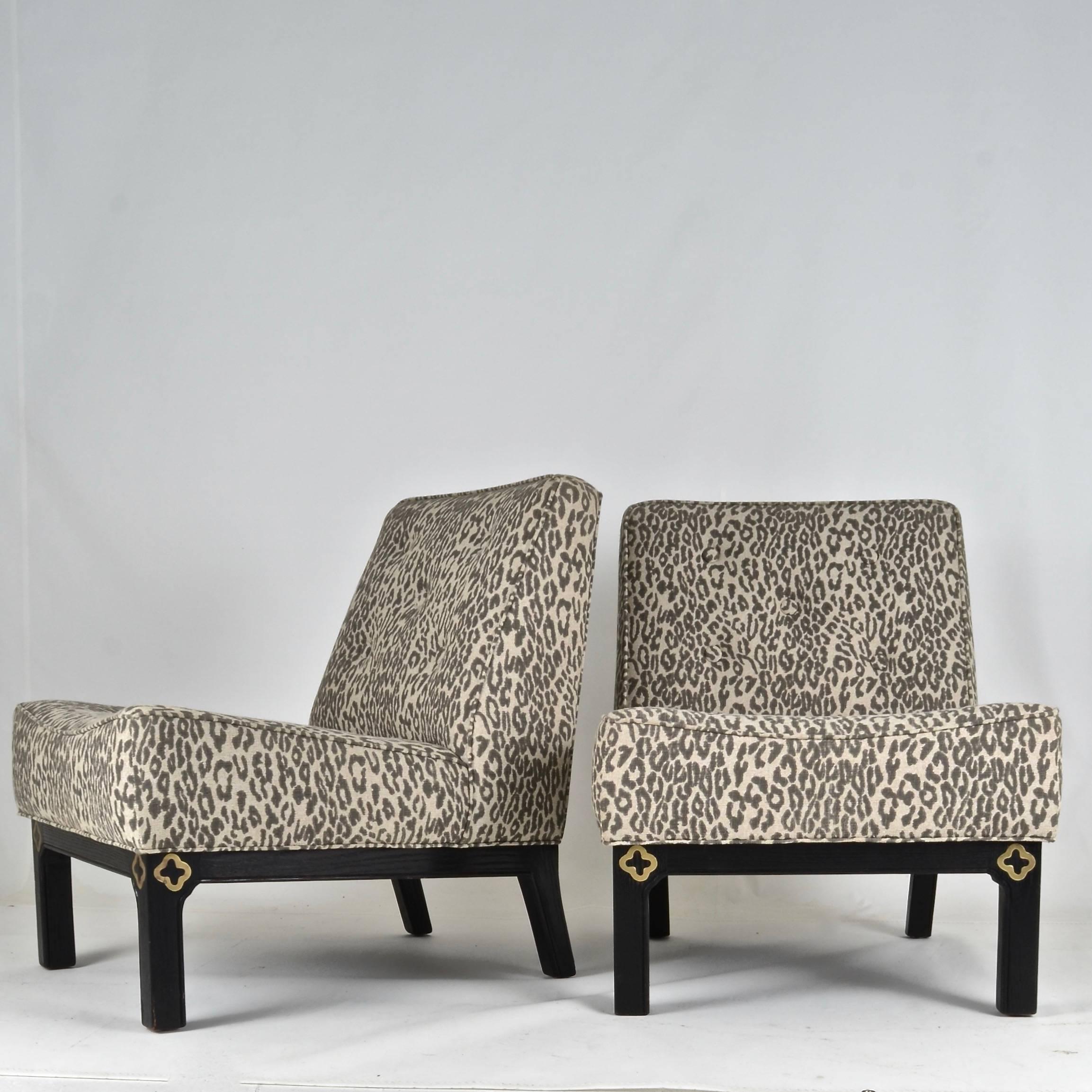 A super pair with great lines, newly upholstered in a leopard print jacquard. Featuring button details and inlaid brass decoration on the front legs. Frame is ebonized retaining wood grain. Very fine quality construction, solid and heavy.