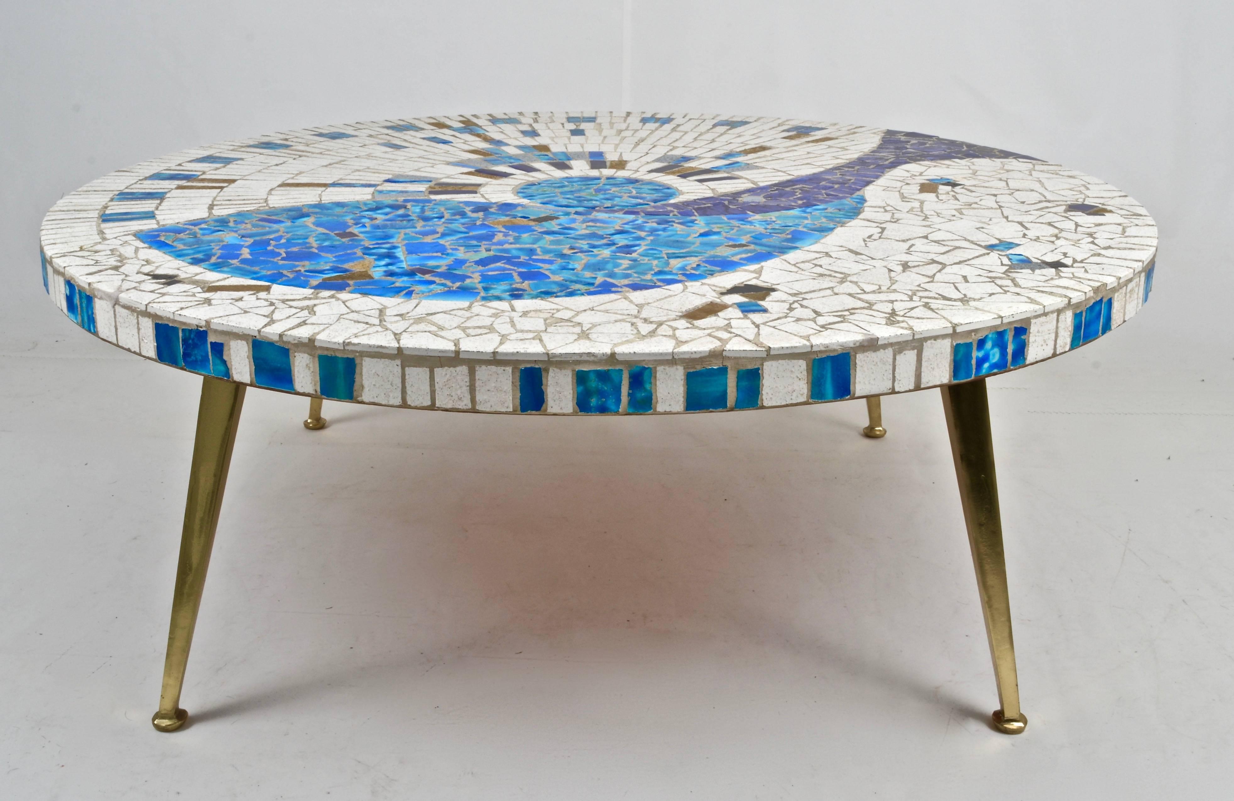 Unusually terrific design and color on this tile-top cocktail table. Modernist tapered brass legs. Very fine vintage condition.