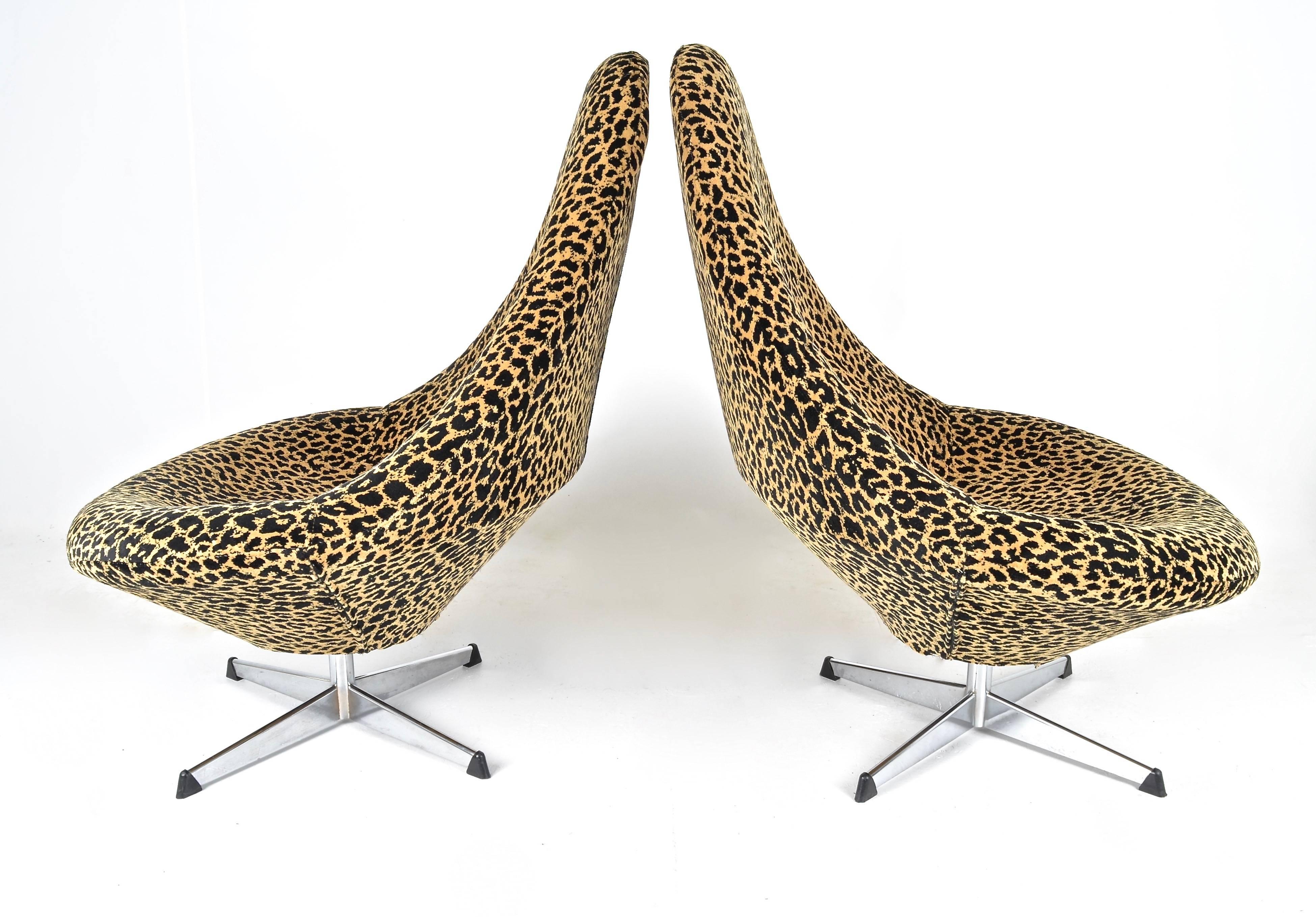 Newly upholstered in quality leopard print jacquard, a sleek and very comfortable pair of vintage swivel chairs. Nice size. Simple steel bases.