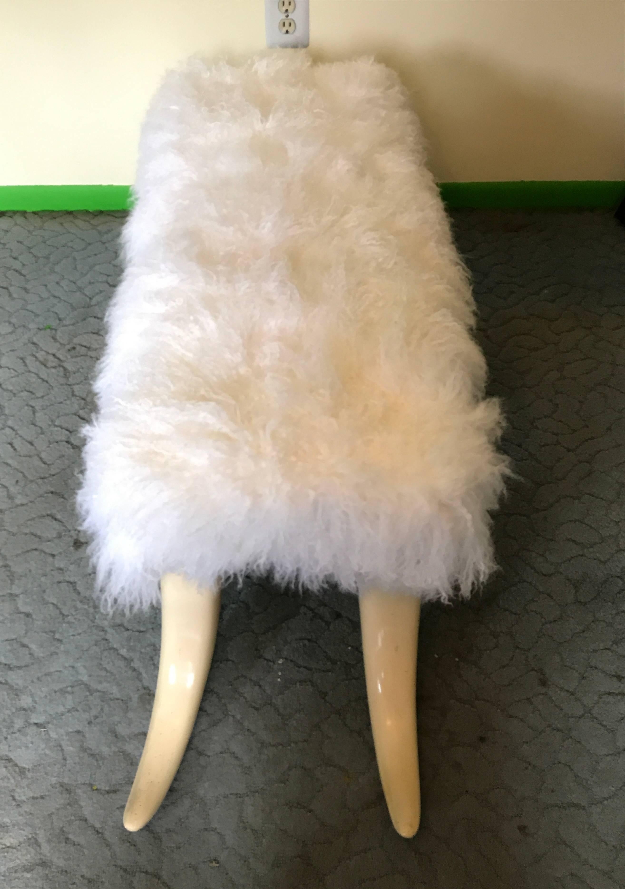 1970s tusk benches,  of rectangular form with new snow white natural long hair goat hair, raised on four realistic composite tusk legs.