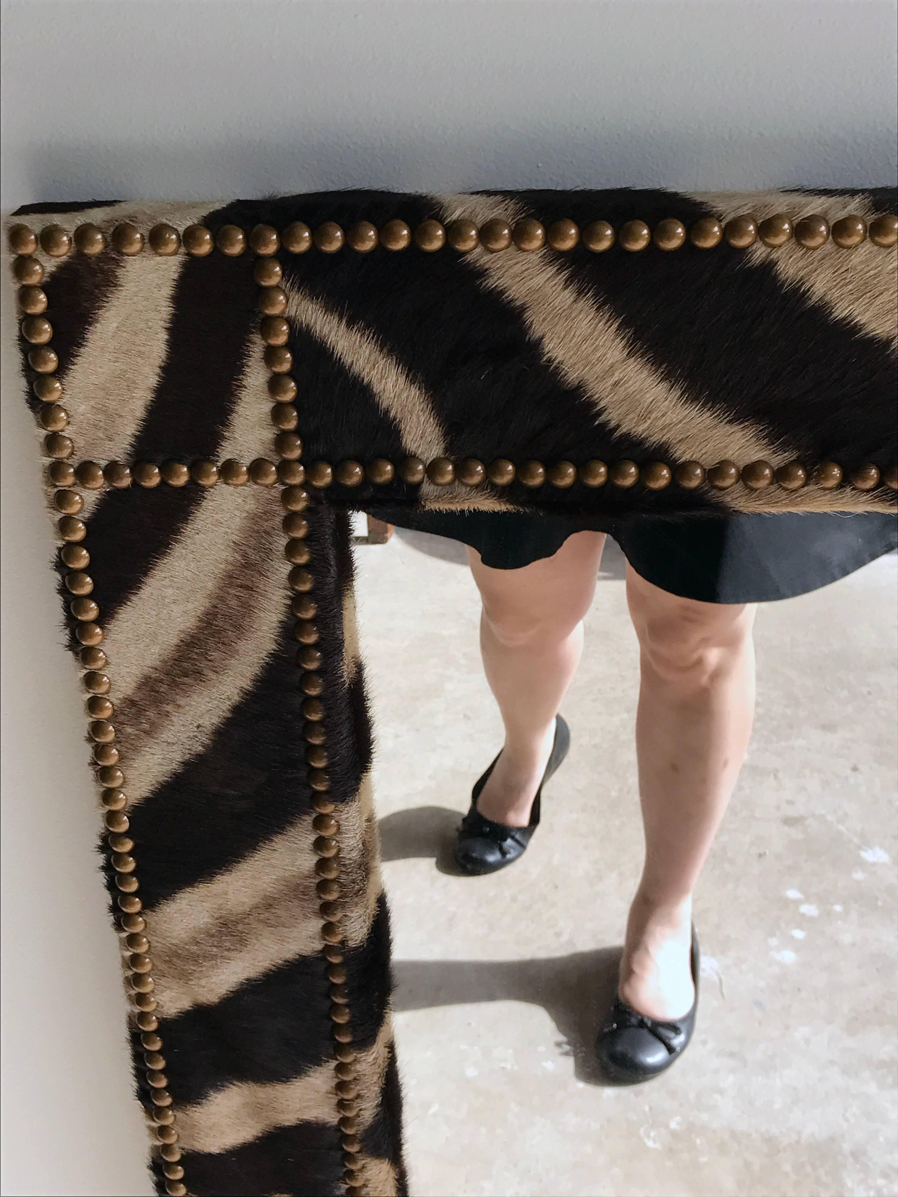 Large zebra hide mirror, of rectangular form with bronze nailhead trim. This mirror is located at our Atlanta Ga, showroom
 