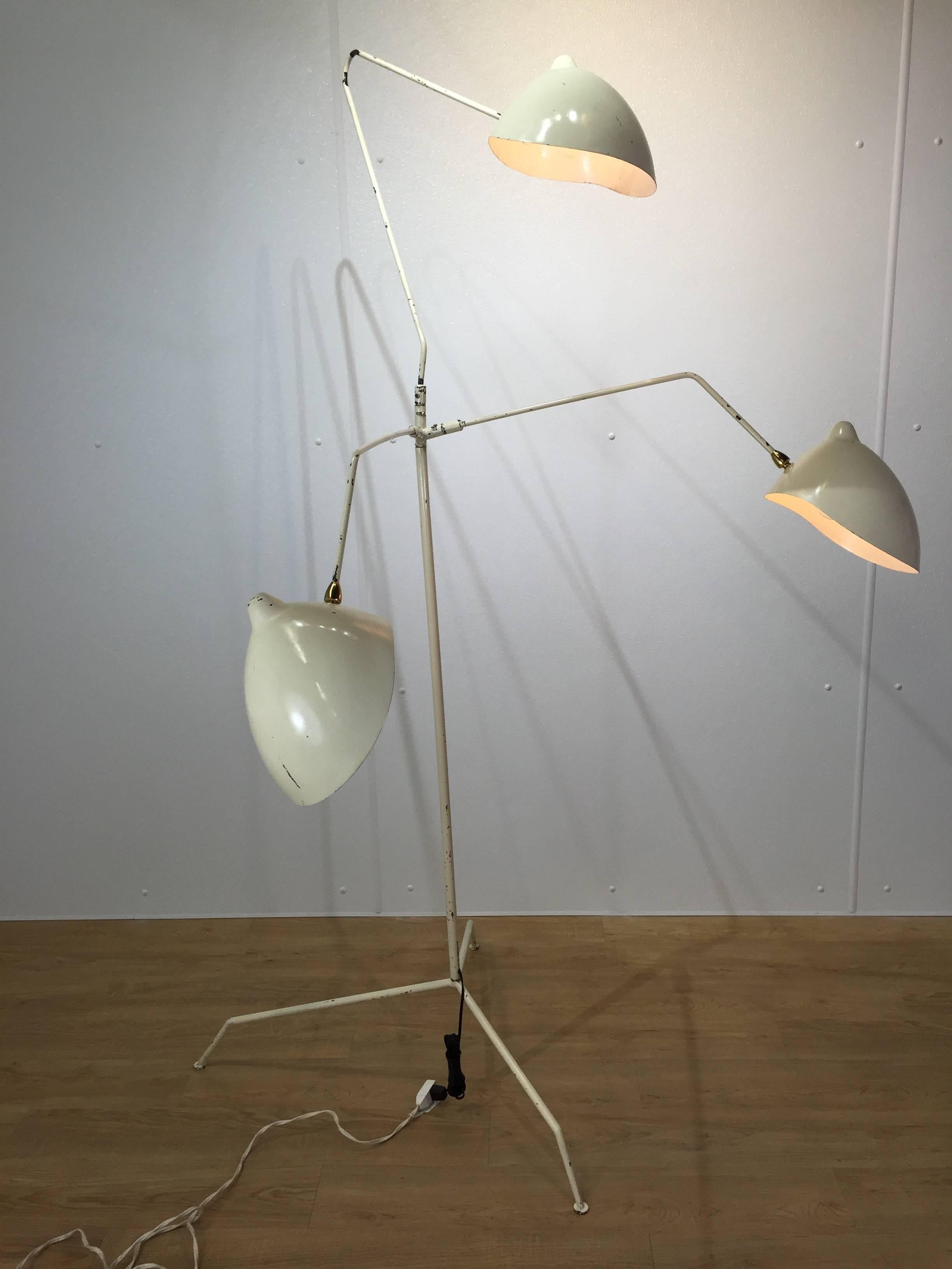 In the Style of Serge Mouille vintage three-arm floor lamp, white enamel finish, adjustable 32" arms, with brass mounts. Very Good vintage condition, wear to paint, signs of use and wear. The original rectangular set screws were replaced with